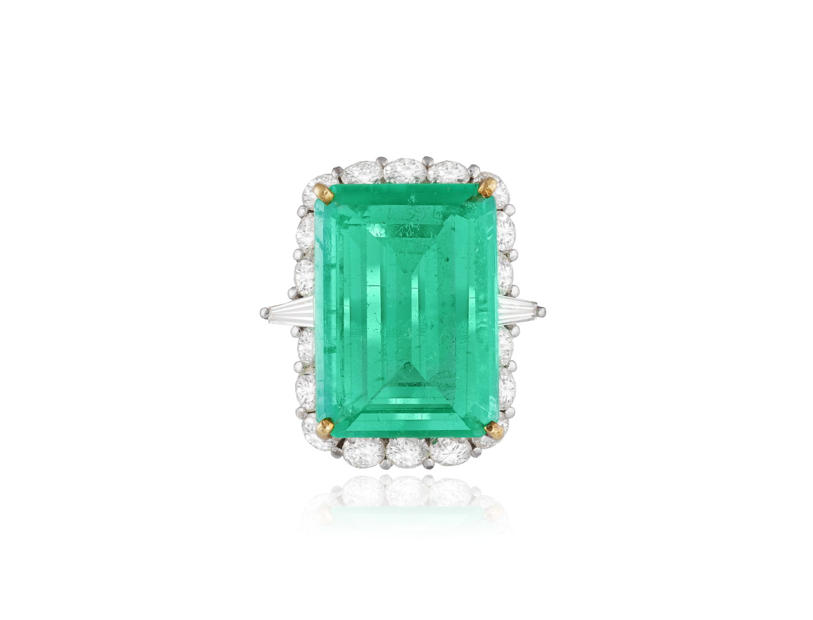 AN EMERALD AND DIAMOND CLUSTER RING • A rectangular cut-cornered emerald, approx. 10.00cts: AN EMERALD AND DIAMOND CLUSTER RING • A rectangular cut-cornered emerald, approx. 10.00cts • brilliant and tapered baguette-cut diamonds • mounted in gold • ring size K