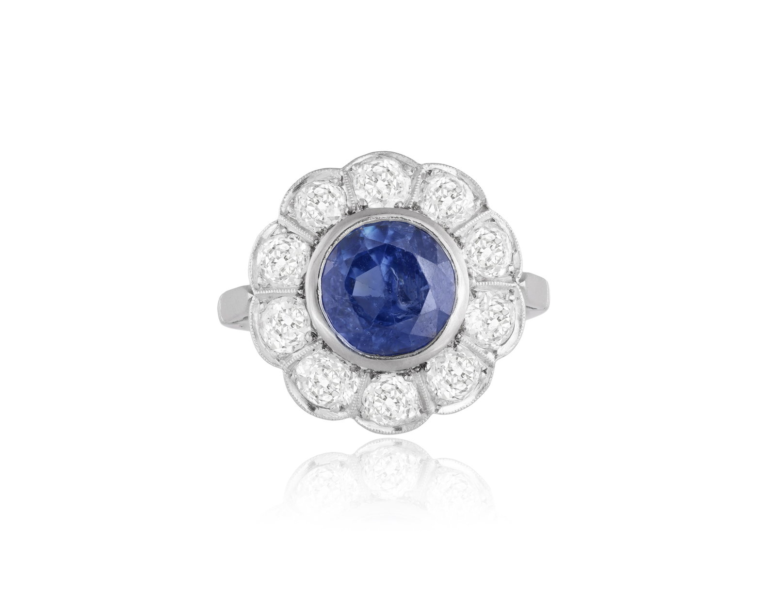 A SAPPHIRE AND DIAMOND CLUSTER RING • Circular-cut sapphire, approx. 2.00cts • old: A SAPPHIRE AND DIAMOND CLUSTER RING • Circular-cut sapphire, approx. 2.00cts • old brilliant-cut diamonds, approx. 1.60cts total • mounted in platinum • French import mark
