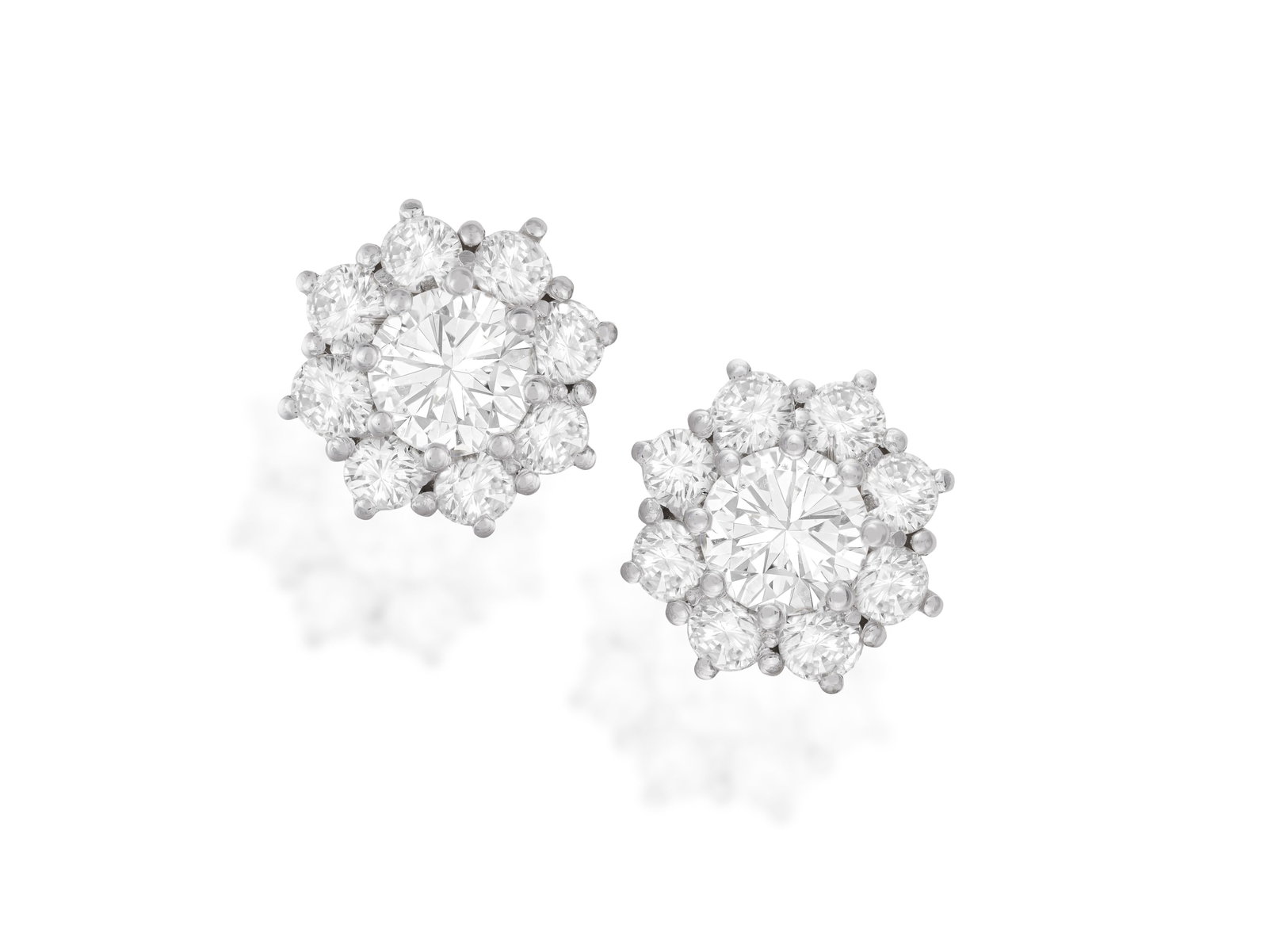 A PAIR OF DIAMOND CLUSTER EARRINGS Each central brilliant-cut diamond within an eight-claw setting,: A PAIR OF DIAMOND CLUSTER EARRINGS Each central brilliant-cut diamond within an eight-claw setting, to a similarly-cut diamond surround, mounted in 18K gold, diamonds approximately 3.20cts total,