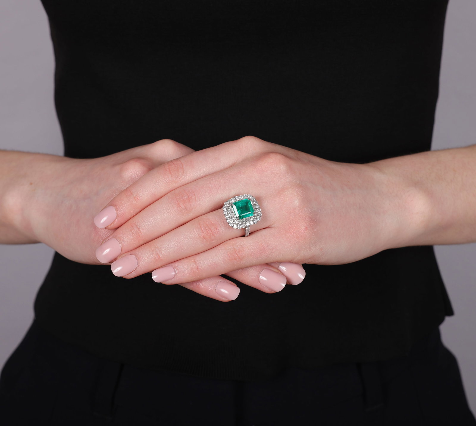 AN EMERALD AND DIAMOND CLUSTER RING • Rectangular-shaped emerald, approx. 3.00cts • - 2