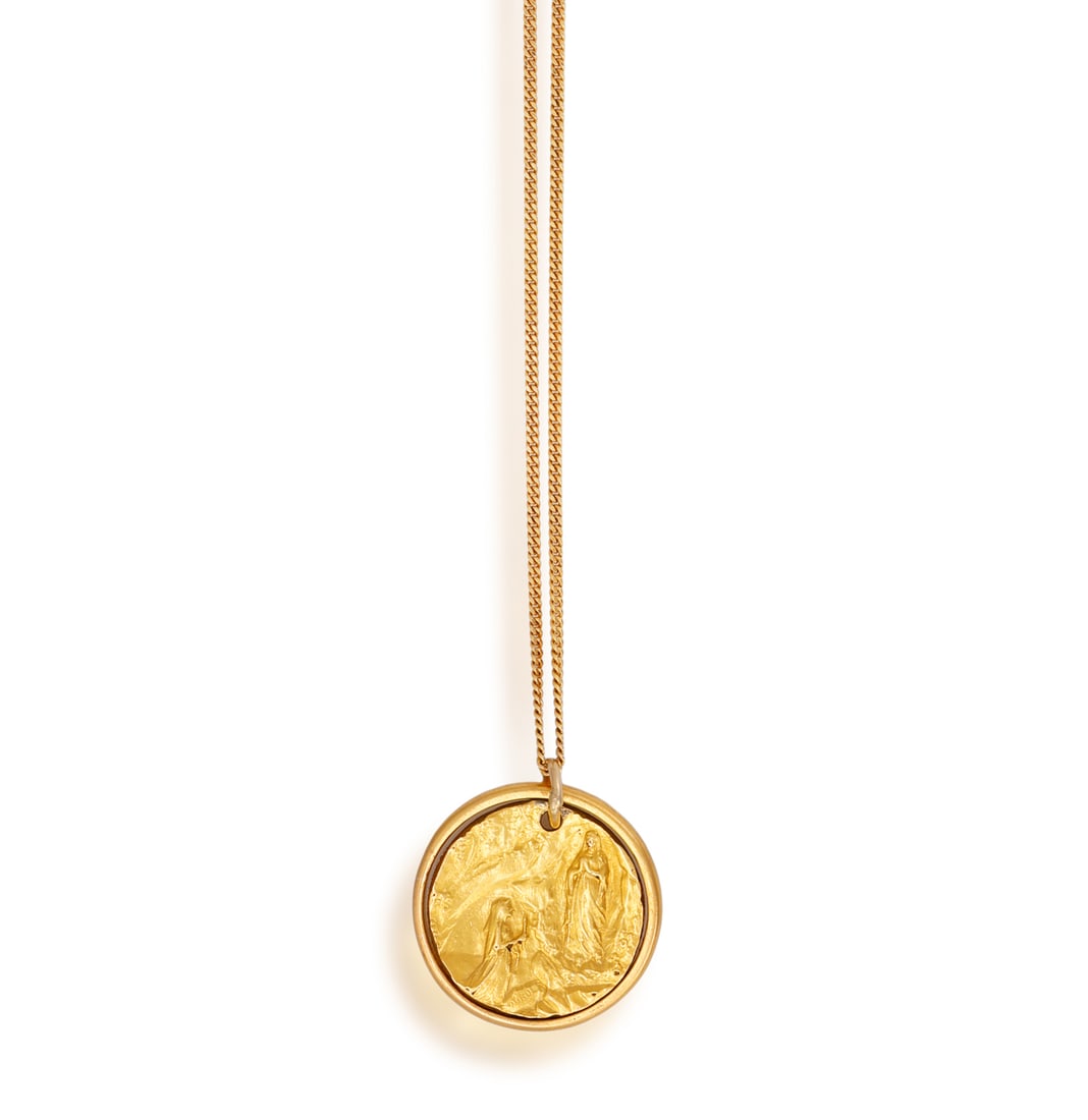 A RELIGIOUS PENDANT ON CHAIN • A circular disk depicting Madonna of Lourdes grotto apparition  (1 of 4)