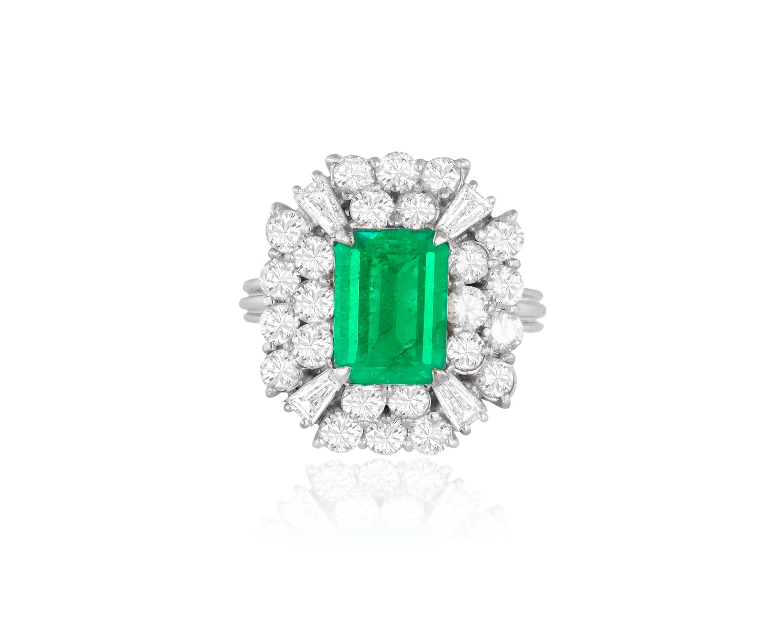 AN EMERALD AND DIAMOND BALLERINA RING, CIRCA 1960 • Rectangular-cut emerald, approx. 3.00cts: AN EMERALD AND DIAMOND BALLERINA RING, CIRCA 1960 • Rectangular-cut emerald, approx. 3.00cts • brilliant and tapered baguette-cut diamonds, approx. 2.10cts total • mounted in 18K gol
