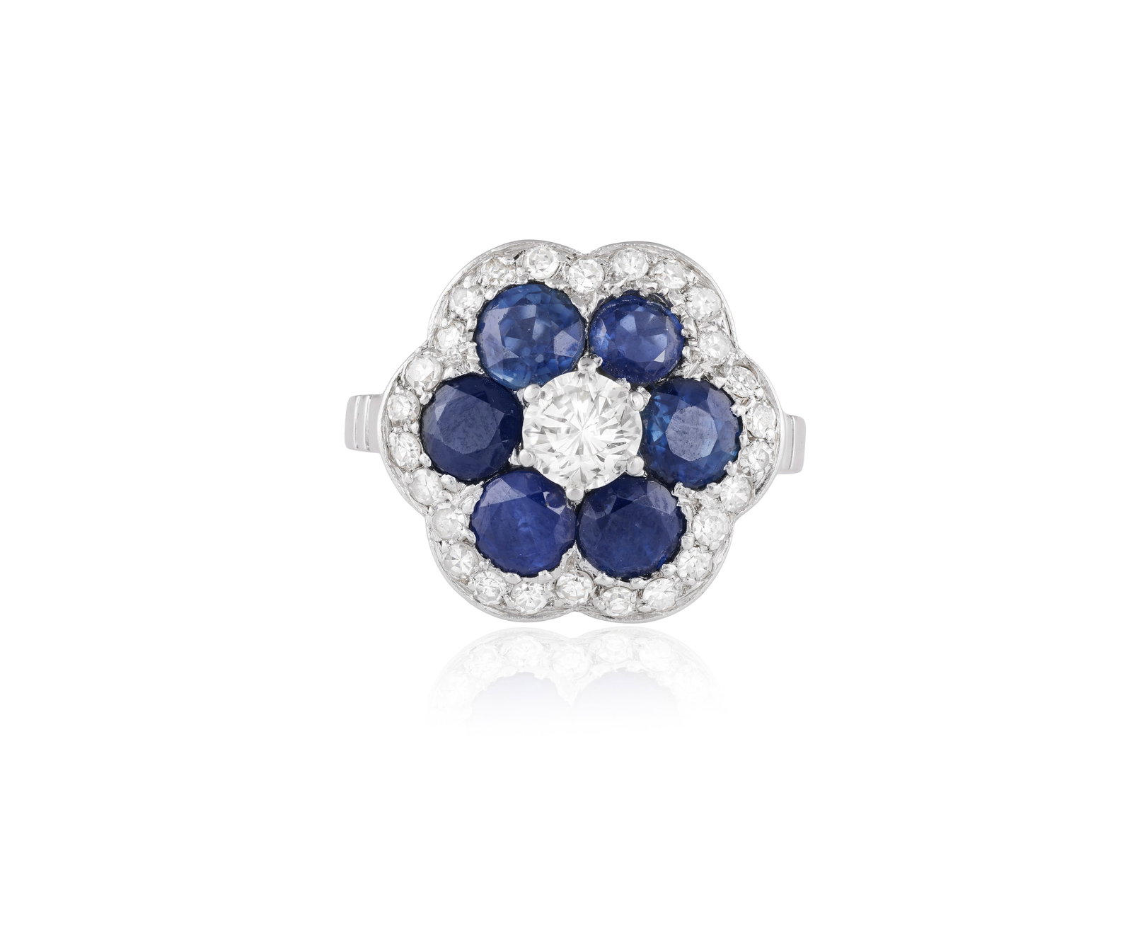 A SAPPHIRE AND DIAMOND CLUSTER RING • Brilliant and single-cut diamonds • circular-cut: A SAPPHIRE AND DIAMOND CLUSTER RING • Brilliant and single-cut diamonds • circular-cut sapphires • mounted in platinum • ring size K⅔