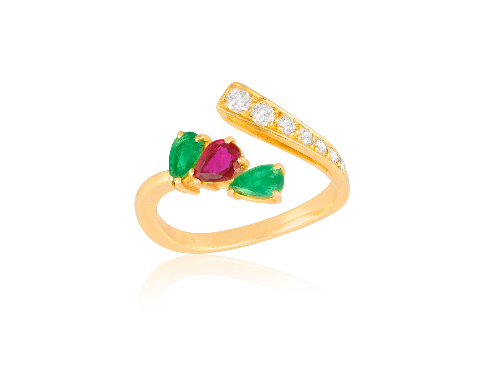 AN EMERALD, RUBY AND DIAMOND CROSSOVER RING • Pear-shaped ruby • two pear-shaped (1 of 3)