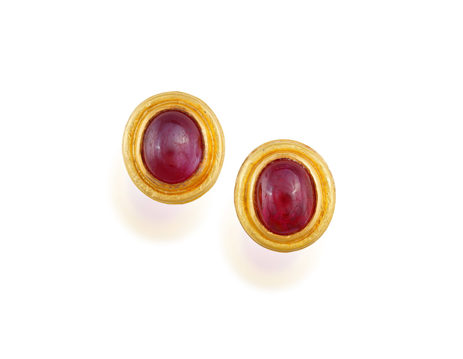 A PAIR OF RUBY EARSTUDS • Oval-shaped ruby cabochons • mounted in 18K gold • (1 of 2)