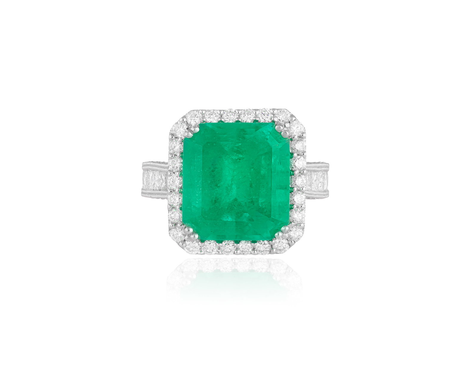 AN EMERALD AND DIAMOND DRESS RING • Cut-cornered rectangular-shaped emerald, approximately: AN EMERALD AND DIAMOND DRESS RING • Cut-cornered rectangular-shaped emerald, approximately 9.50cts • brilliant and princess-cut diamonds, approx. 1.50cts total • mounted in 18K gold 