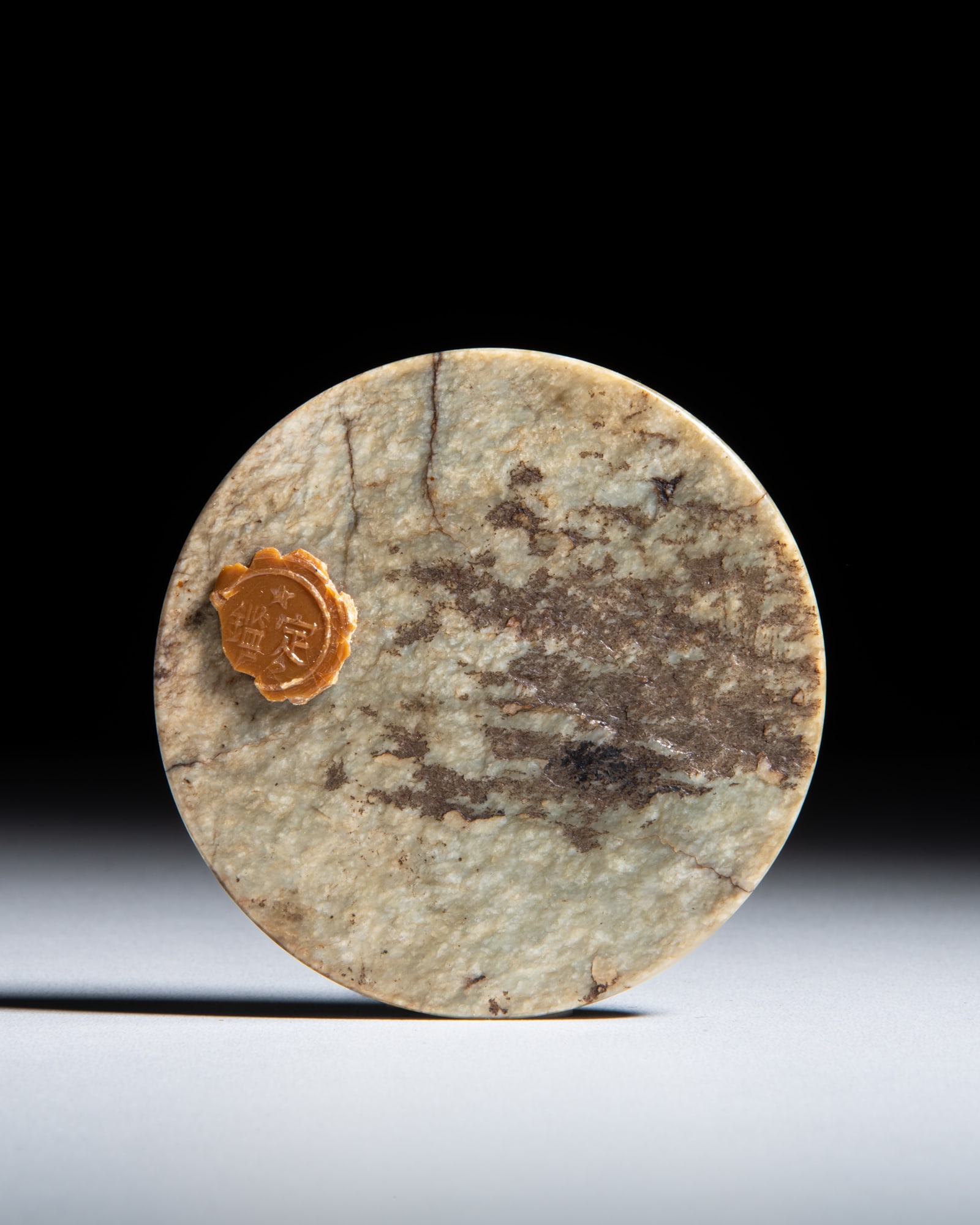 AN UNUSUAL CELADON AND RUSSET JADE DISC 汉代 青玉带沁色: AN UNUSUAL CELADON AND RUSSET JADE DISC 汉代 青玉带沁色玉璧 China, Han dynasty (202BC-220AD) D.7.2cm Provenance: A Paris art instructor’s co
