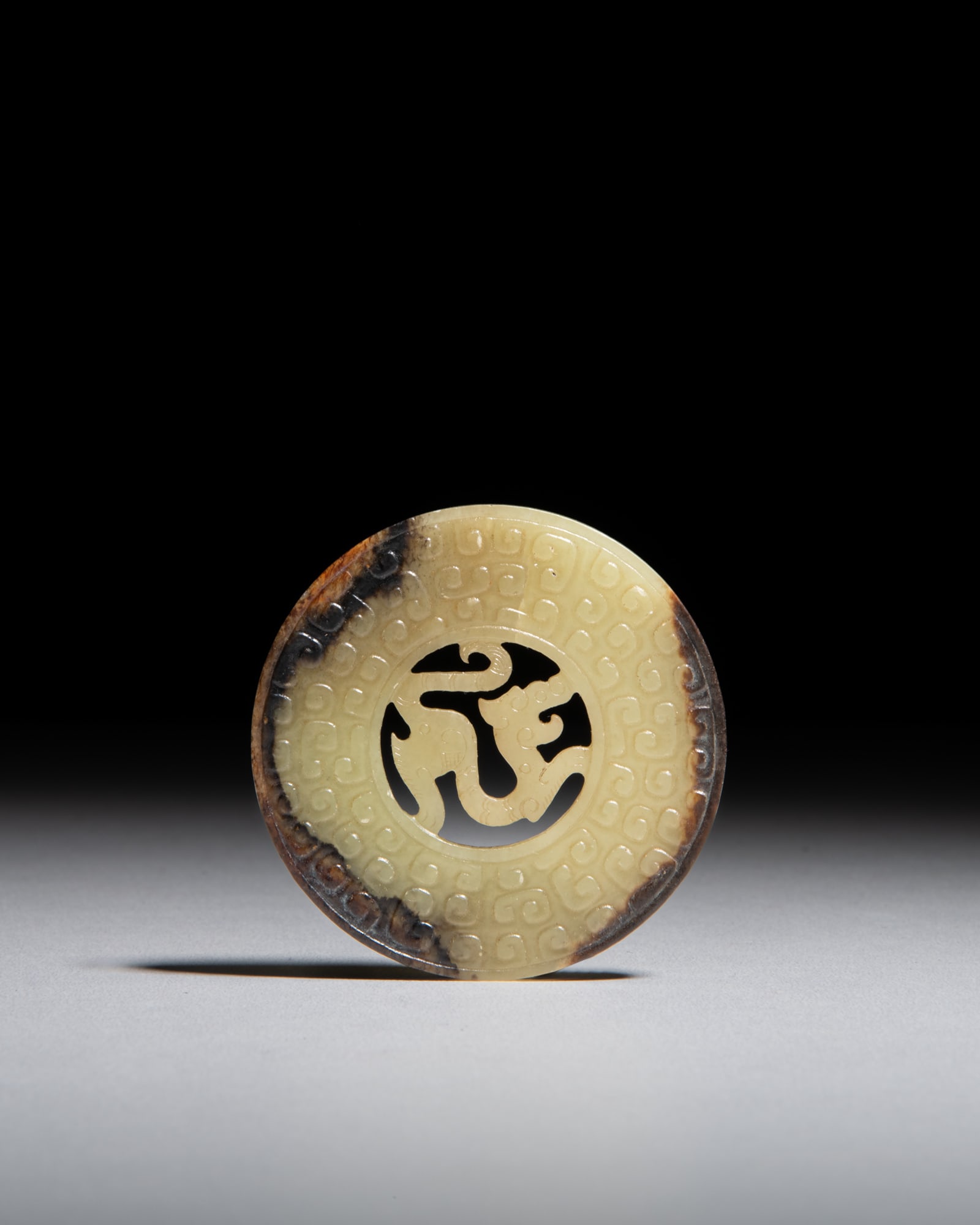 A YELLOW JADE WITH RUSSET 'DRAGON' DISC 汉代 黄玉带沁色 (1 of 2)