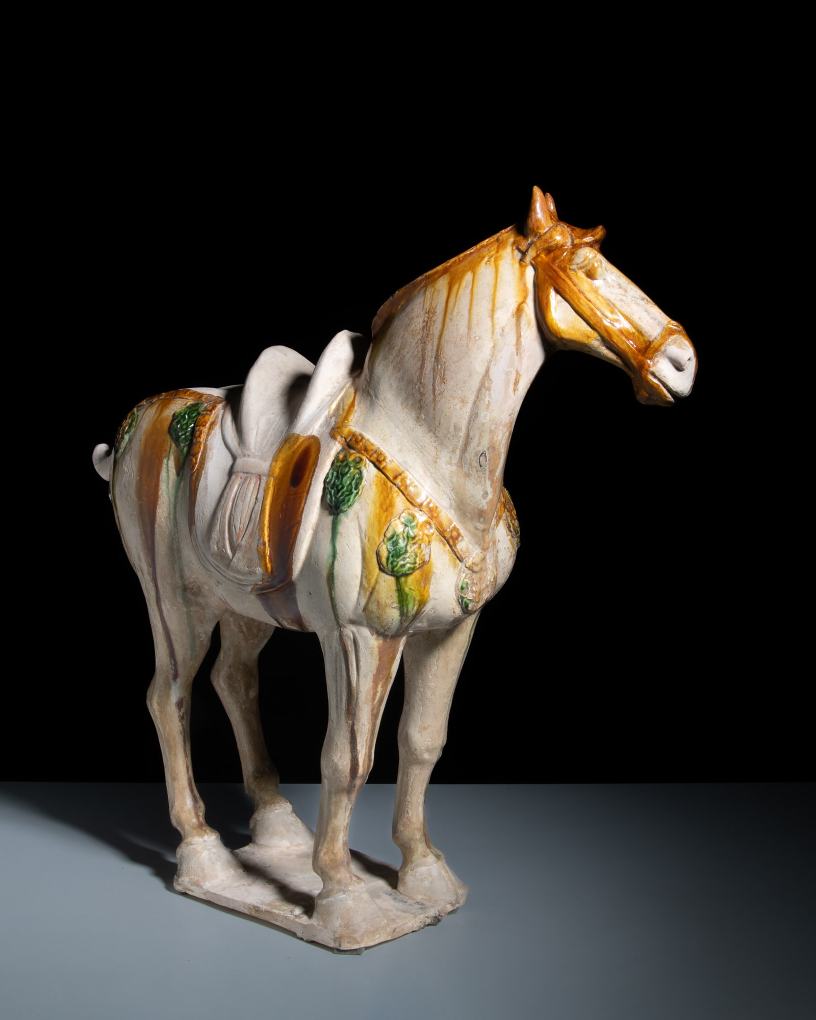 A RARE GREEN AND AMBER GLAZED POTTERY HORSE 唐代 三彩马 China, Tang: A RARE GREEN AND AMBER GLAZED POTTERY HORSE 唐代 三彩马 China, Tang dynasty (618-907) H.52cm Provenance: A Paris art instructor’s collection, purchased at Sadde, Di
