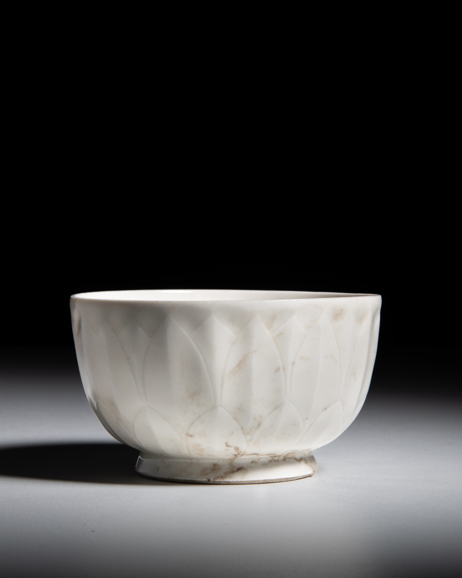 A CARVED DING WHITE-GLAZED ‘LOTUS’ BOWL 宋代 定窑莲ń (1 of 2)