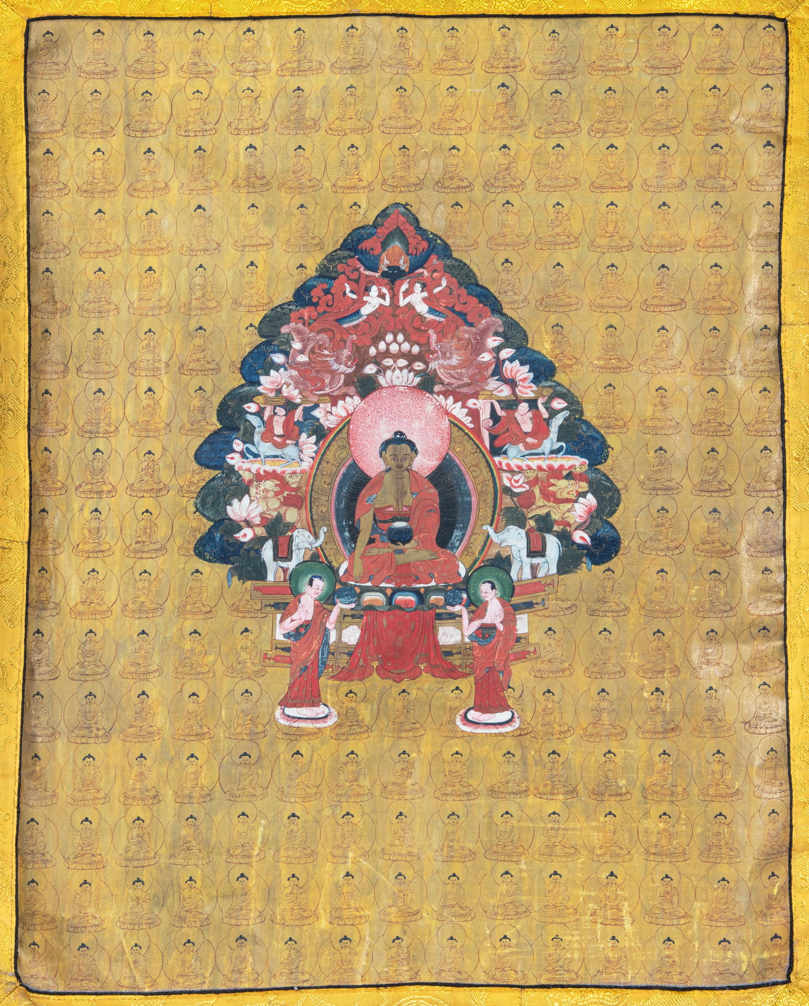 A POLYCHROME THANGKA ON A GOLDEN YELLOW GROUND WITH SHAKYAMUNI AND ASSISTANT AMONG THE THOUSAND (1 of 2)
