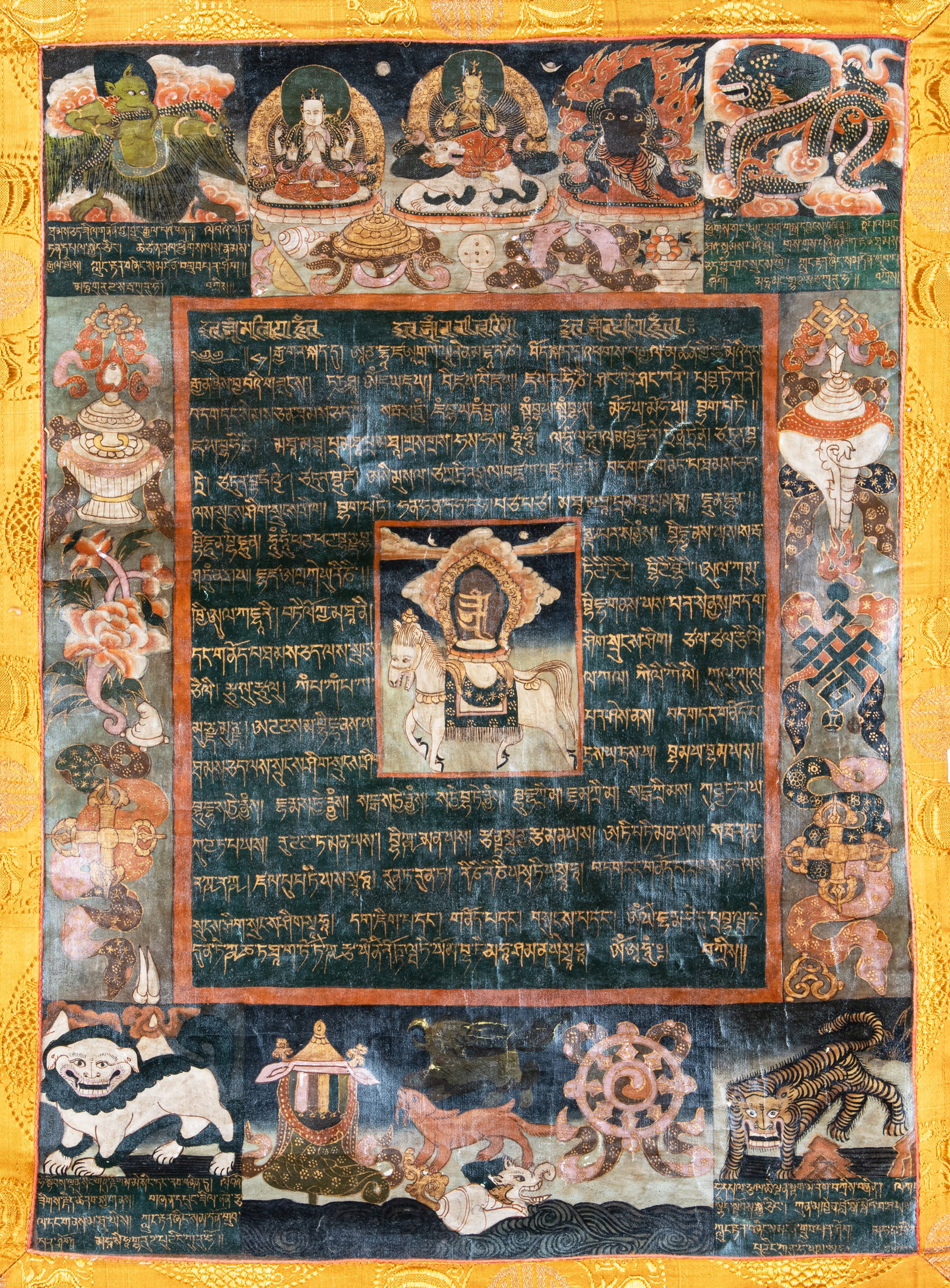 A POLYCHROME AND GILT THANGKA ON CLOTH WITH THE HORSE OF WIND LUNGTA CARRYING THE CINTAMANI AMONG (1 of 2)