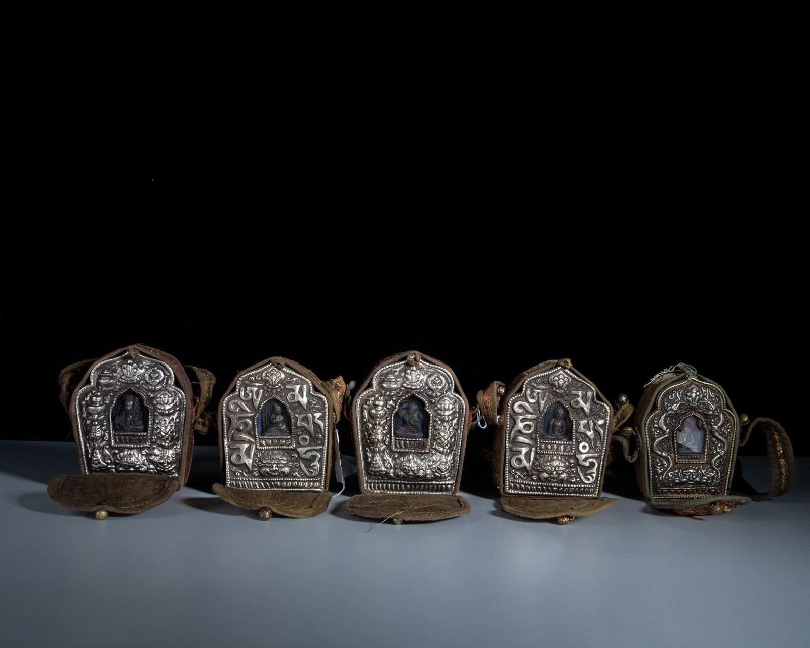 A SET OF FIVE SMALL SHRINE-SHAPED MIXED-METAL GAU BOXES WITH THEIR CONTENTS AND CLOTH COVERS Tibet (1 of 1)