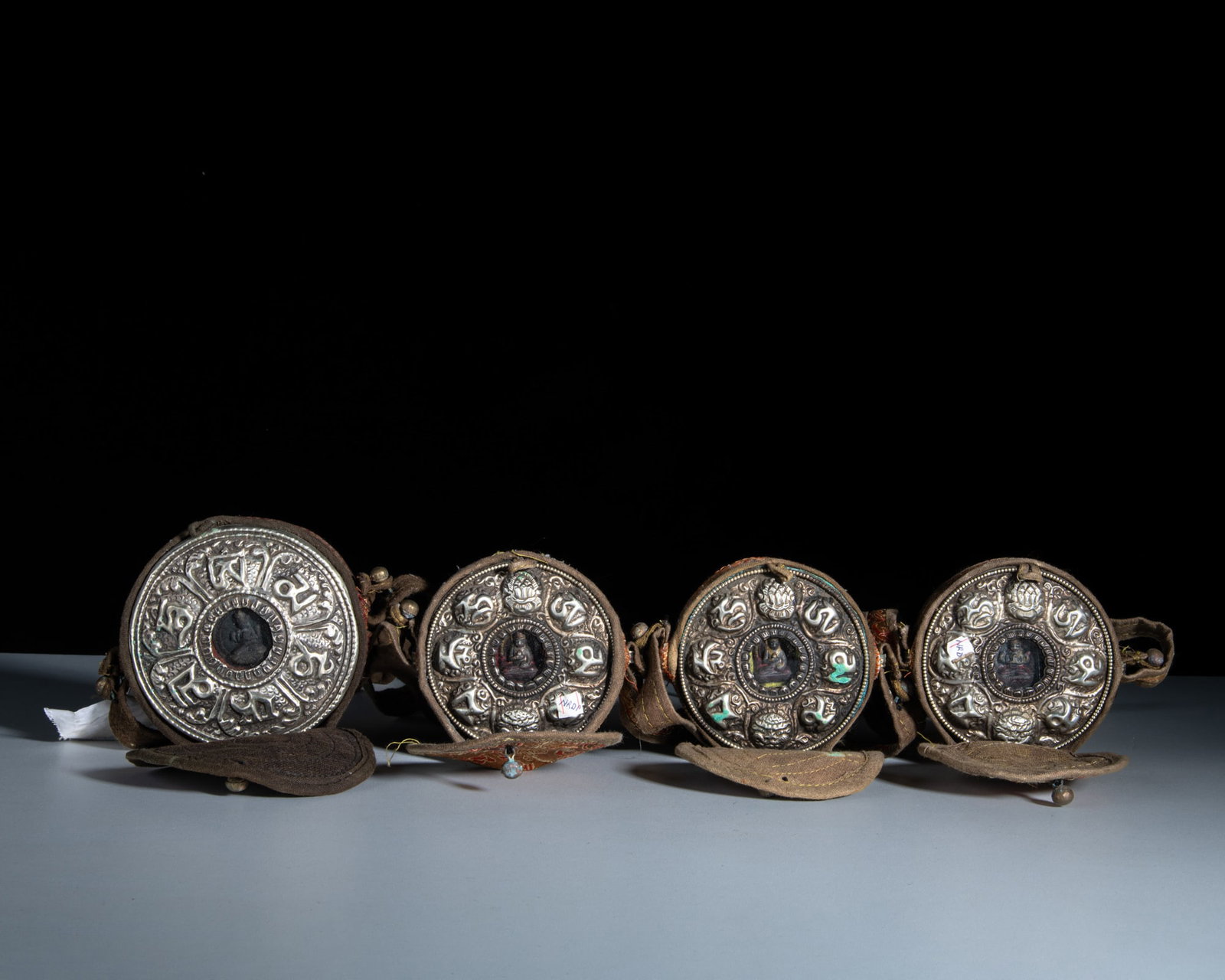 A SET OF FOUR SMALL CIRCULAR MIXED-METAL GAU BOXES WITH THEIR CONTENTS AND CLOTH COVERS Tibet or (1 of 1)