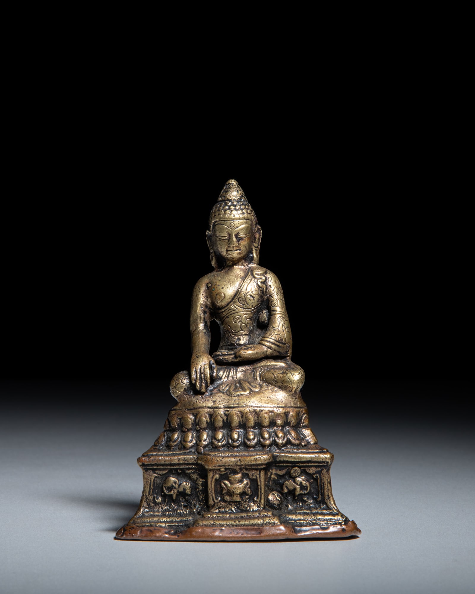 A SMALL COPPER ALLOY FIGURE OF A BUDDHA Tibet, 20th Century depicts Buddha Shakyamuni seated in (1 of 3)