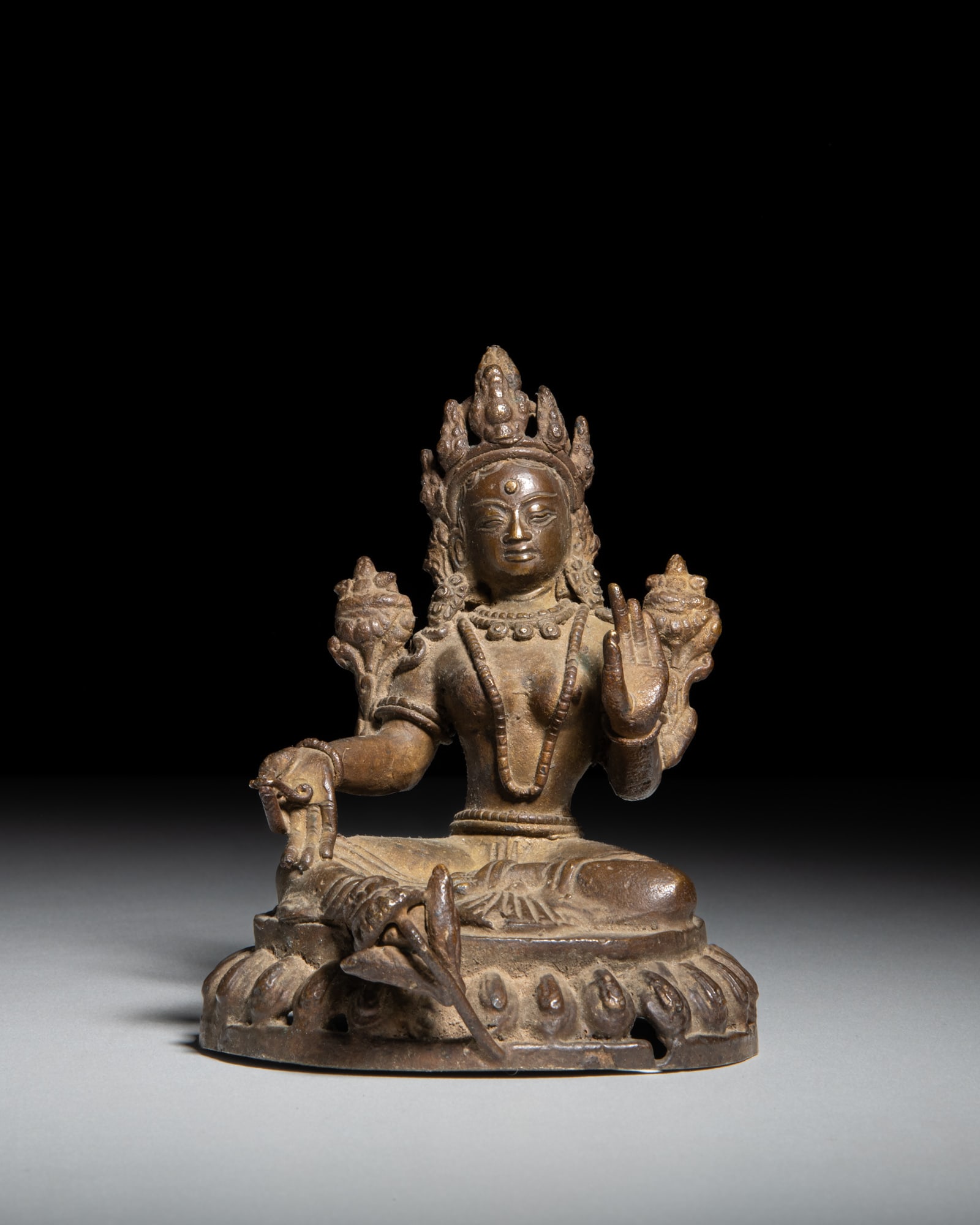 A COPPER ALLOY FIGURE OF A GREEN TARA Nepal, middle 20th Century depicts the saviouress (1 of 3)