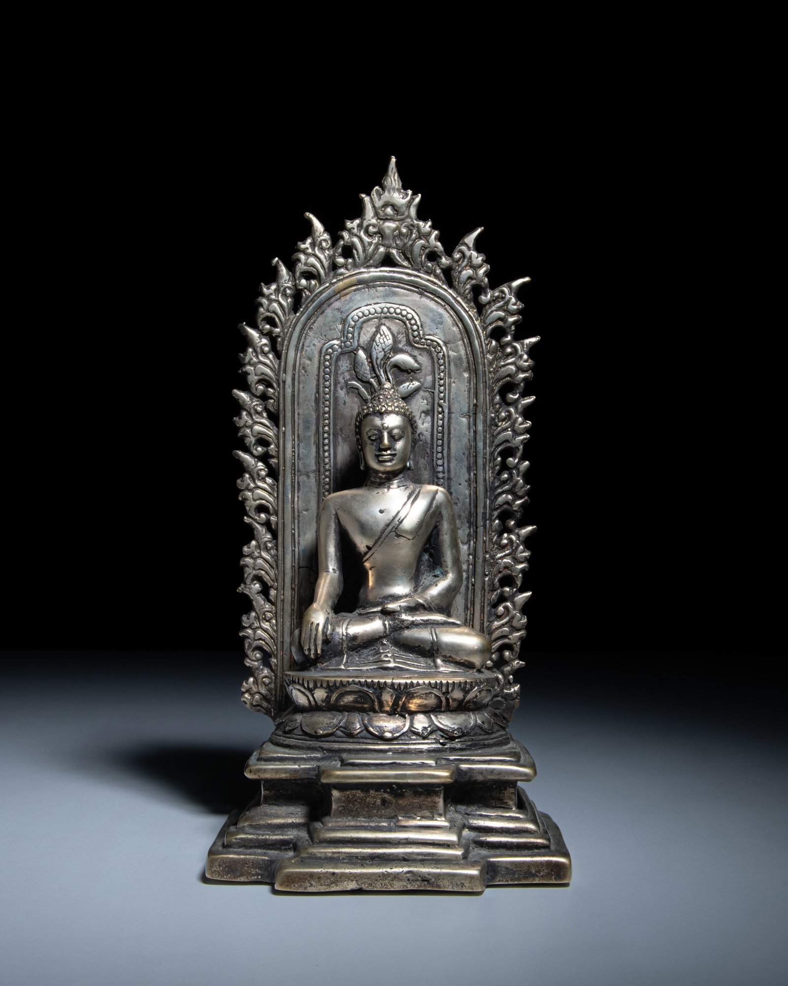 A SILVERED BRONZE BUDDHA IN THE 9TH-10TH CENTURY SRIVIJAYA STYLE Indonesia or Thailand, 20th (1 of 3)