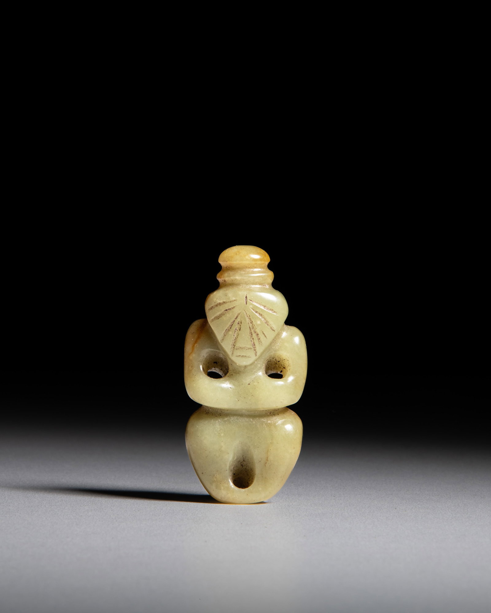 A YELLOW JADE SEATED FIGURE WITH BROWNISH-RED RUSSET PATINA 红山文化: A YELLOW JADE SEATED FIGURE WITH BROWNISH-RED RUSSET PATINA 红山文化 黄玉神人像 China, Hongshan culture (BC4000-BC3000) H.6.4cm