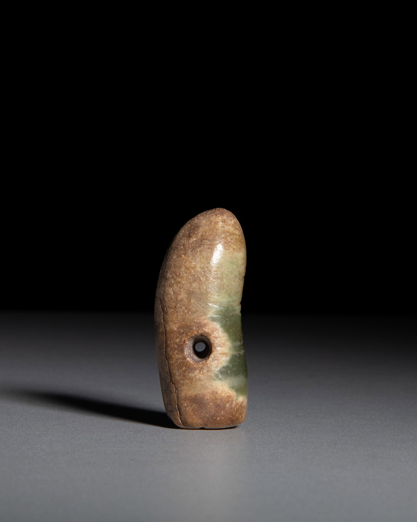 A CELADON JADE PENDANT CARVED IN THE FORM OF A CICADA, WITH CALCIFIED PATINA 红山 (1 of 2)