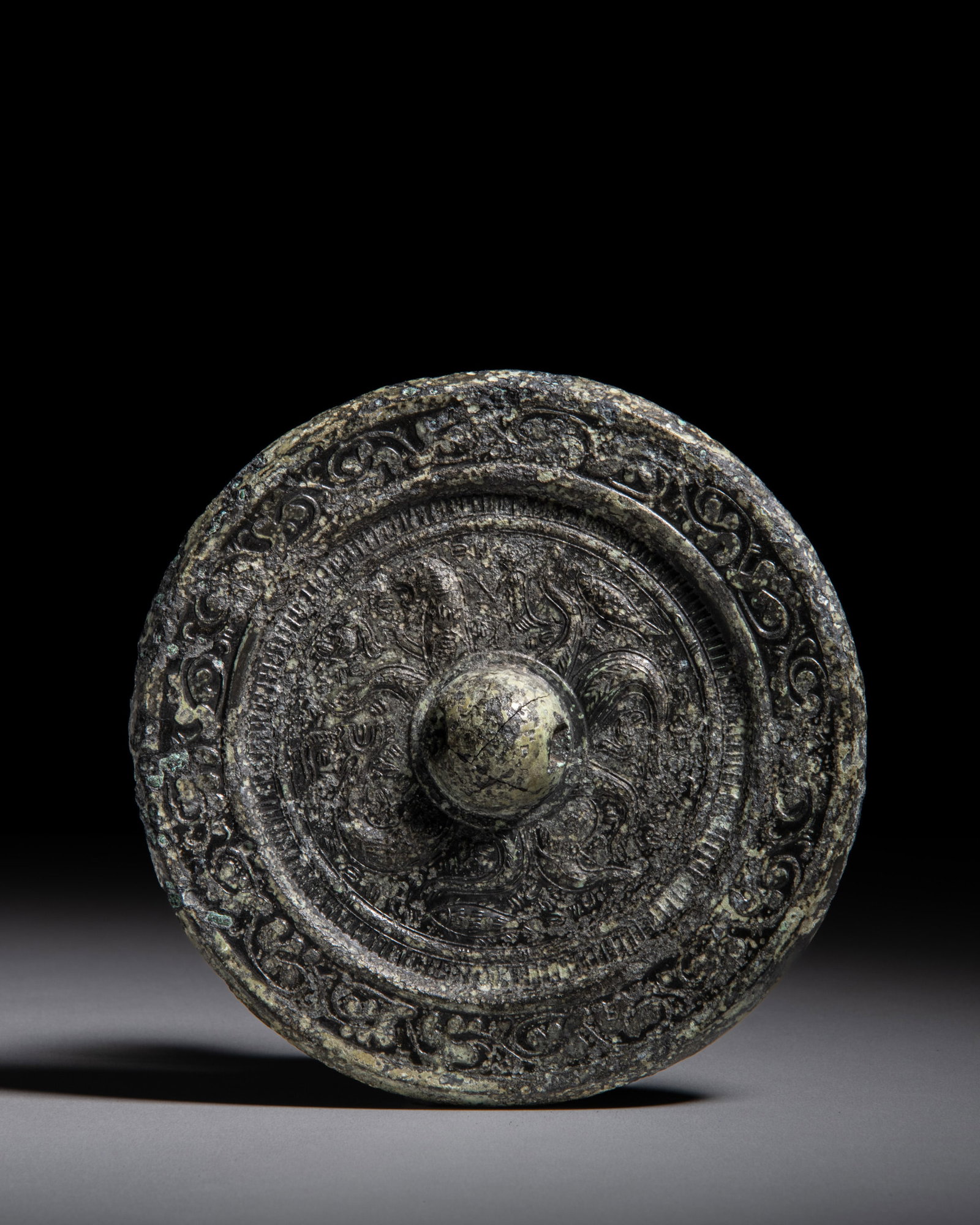 A RARE CIRCULAR BRONZE MIRROR WITH THE XUANWU (NORTHERN TORTOISE-AND-SNAKE DEITY) MOTIF 汉 (1 of 2)
