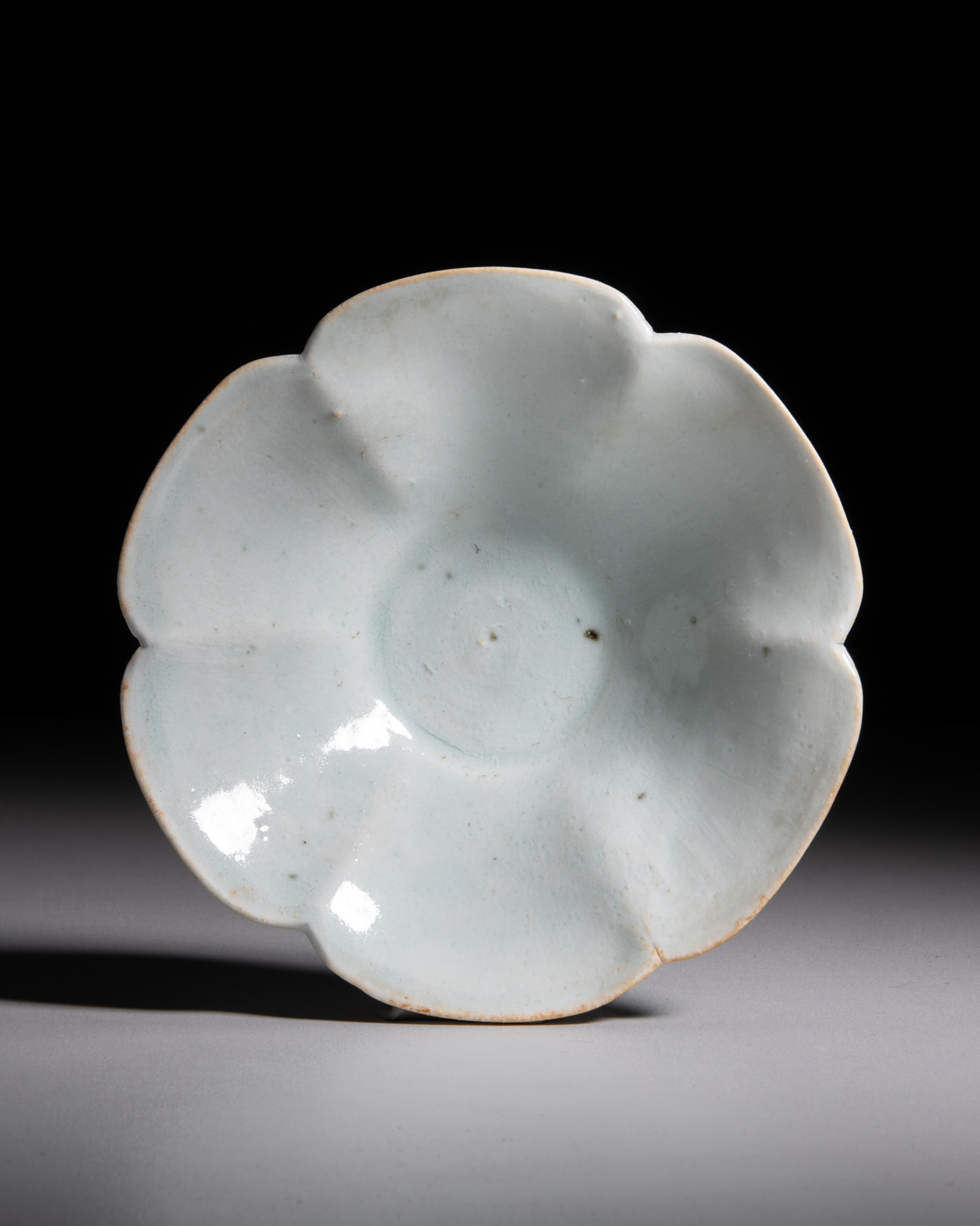 A QINGBAI GLAZED FLOWER SHAPE BOWL 宋 青白花口小盏: A QINGBAI GLAZED FLOWER SHAPE BOWL 宋 青白花口小盏 China, Song dynasty D.13.1cm Provenance: English diplomatic collection, acquired in Beijing in the 1950s