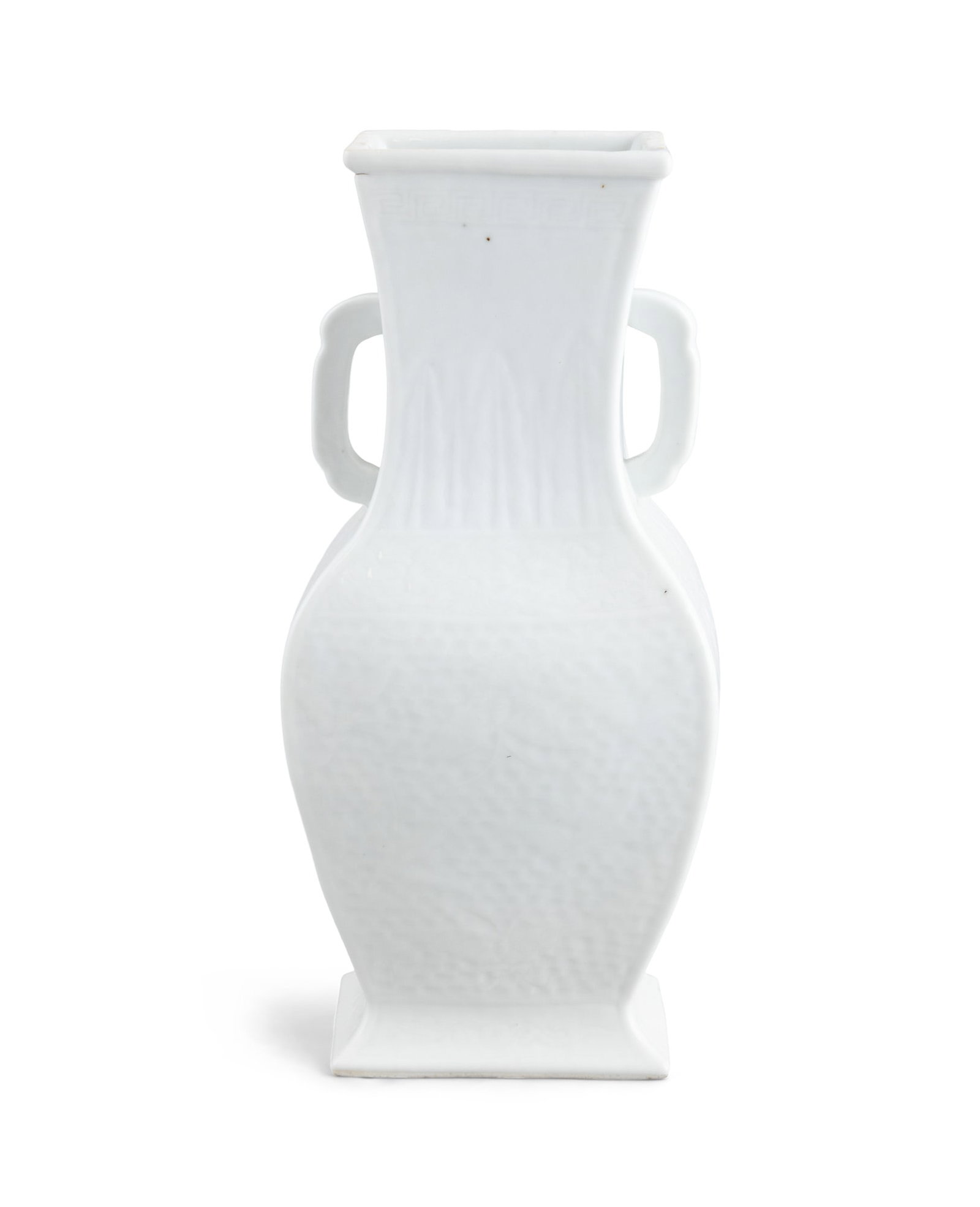 A WHITE GLAZED 'BUTTERFLIES AND FLOWERS' QUADRANGULAR HANDLED VASE 民国 白釉: A WHITE GLAZED 'BUTTERFLIES AND FLOWERS' QUADRANGULAR HANDLED VASE民国 白釉花蝶纹四方瓶China, Republic periodH.29cm