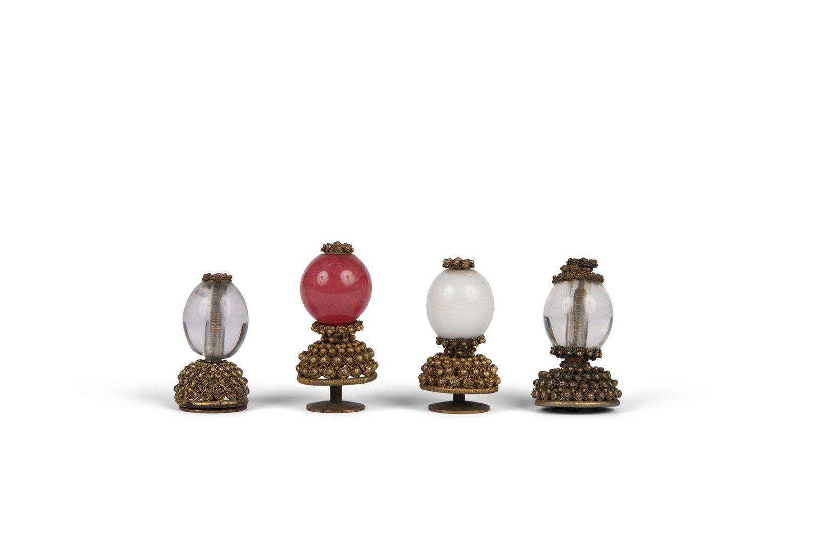 A GROUP OF FOUR MANDARIN HAT BUTTONS 晚清 料器官帽帽: A GROUP OF FOUR MANDARIN HAT BUTTONS 晚清 料器官帽帽顶一组四件 China, late Qing dynasty Each mounted in gilt metal, the buttons 