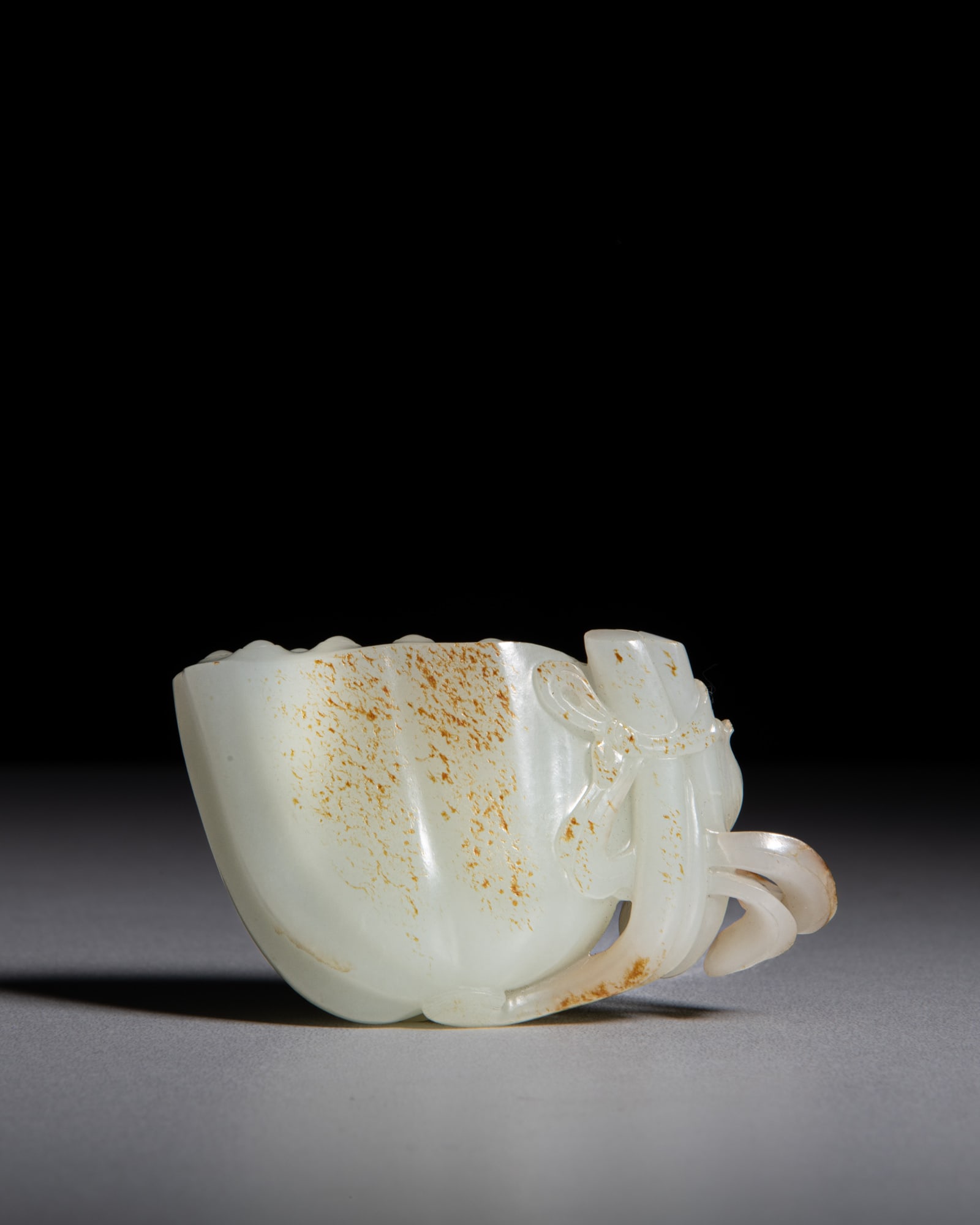 A FINE CARVED PALE JADE 'LOTUS ROOT' PENDANT 清18世纪 青白玉: A FINE CARVED PALE JADE 'LOTUS ROOT' PENDANT 清18世纪 青白玉带沁色‘一把莲’手把件 China, Qing 18th 