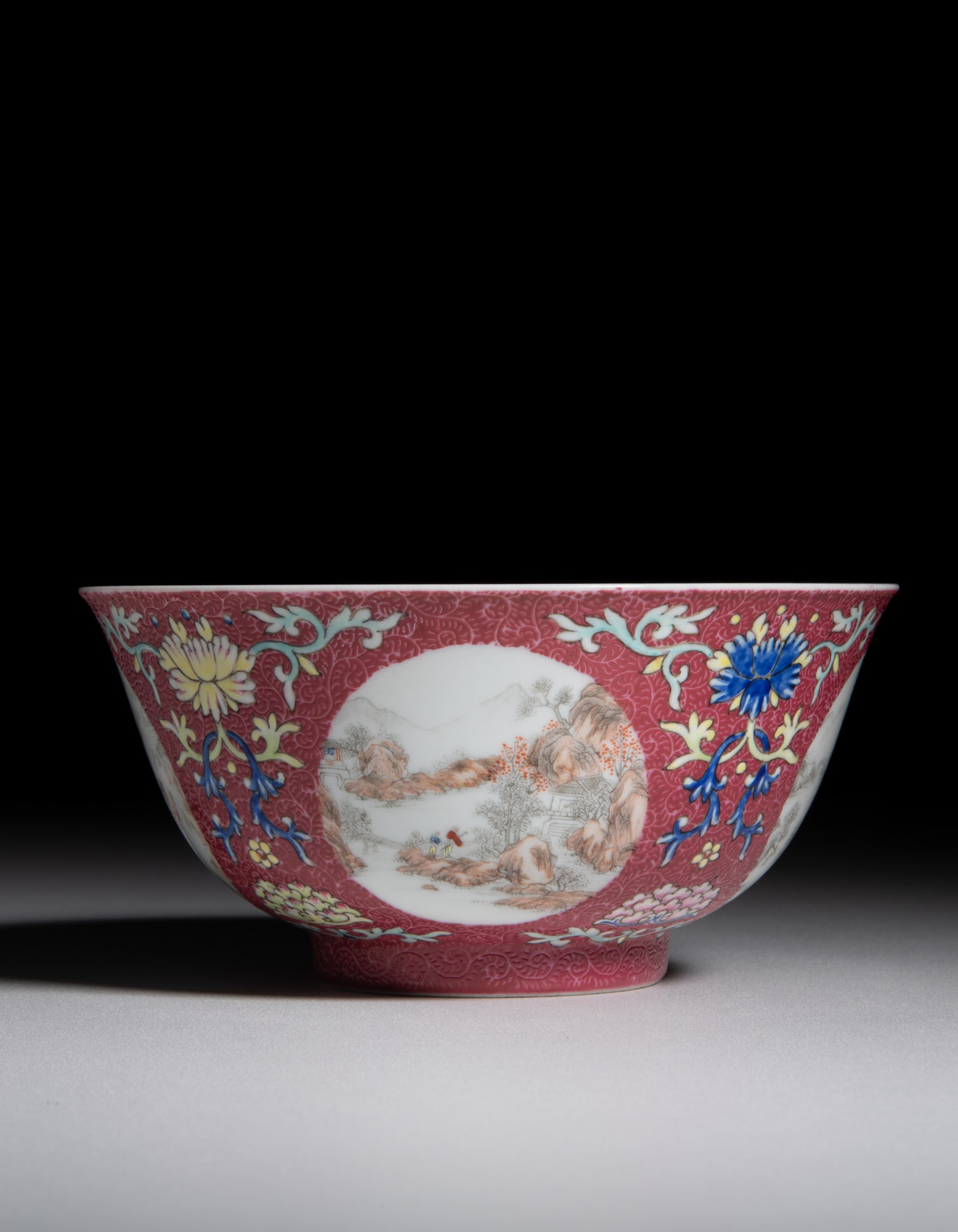 A CHINESE FAMILLE ROSE RUBY-GROUND SGRAFFITO ‘FIGURES AND LANDSCAPES’ MEDALLION BOWL (1 of 6)