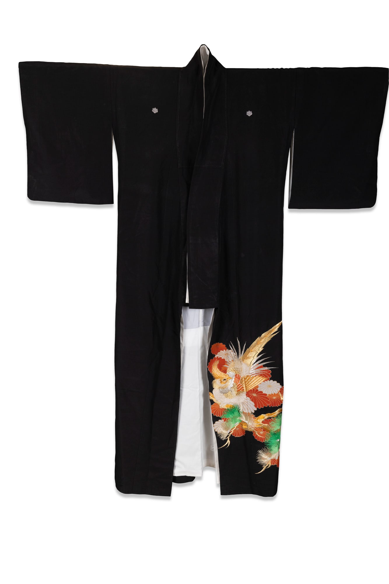 A JAPANESE BLACK-GROUND SILK KURO-TOMESODE Japan, 20th century, Shōwa period of traditional: A JAPANESE BLACK-GROUND SILK KURO-TOMESODE Japan, 20th century, Shōwa period of traditional form, woven with a fine black silk ground. The lower skirt panel is richly decorated with a dynamic and