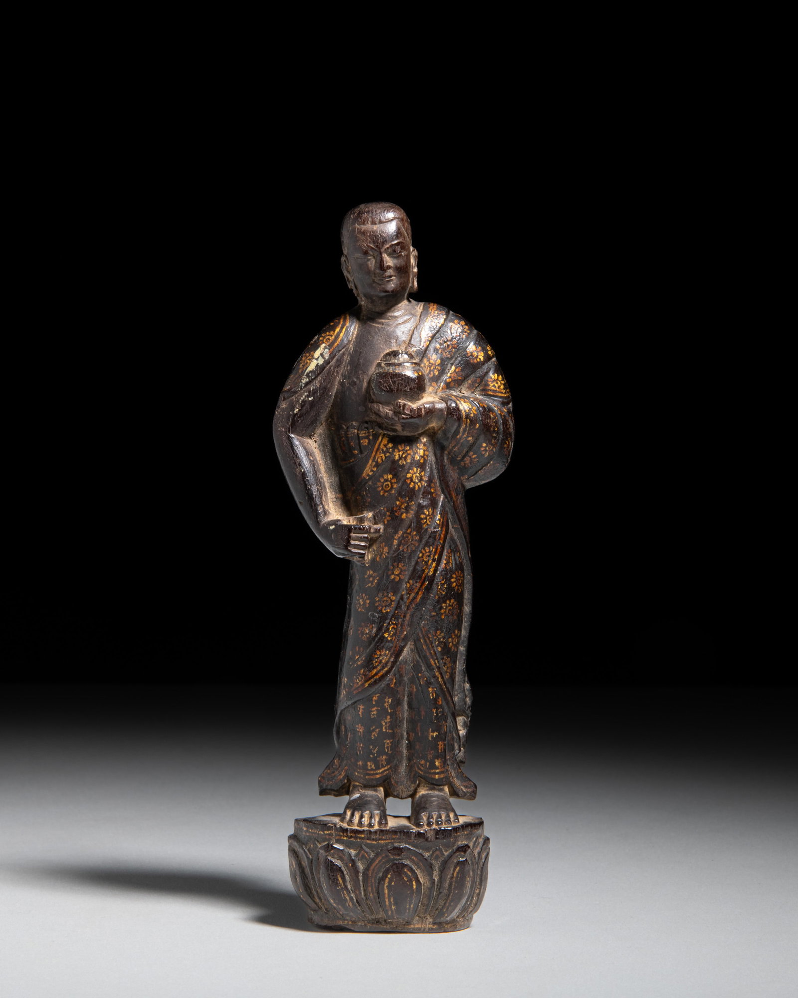 A VERY RARE GILT-DECORATED ZITAN WOOD FIGURE OF BHAIṢAJYAGURU (MEDICINE BUDDHA) 西: A VERY RARE GILT-DECORATED ZITAN WOOD FIGURE OF BHAIṢAJYAGURU (MEDICINE BUDDHA) 西藏 15-16世纪 紫檀描金药师佛立像 Ti