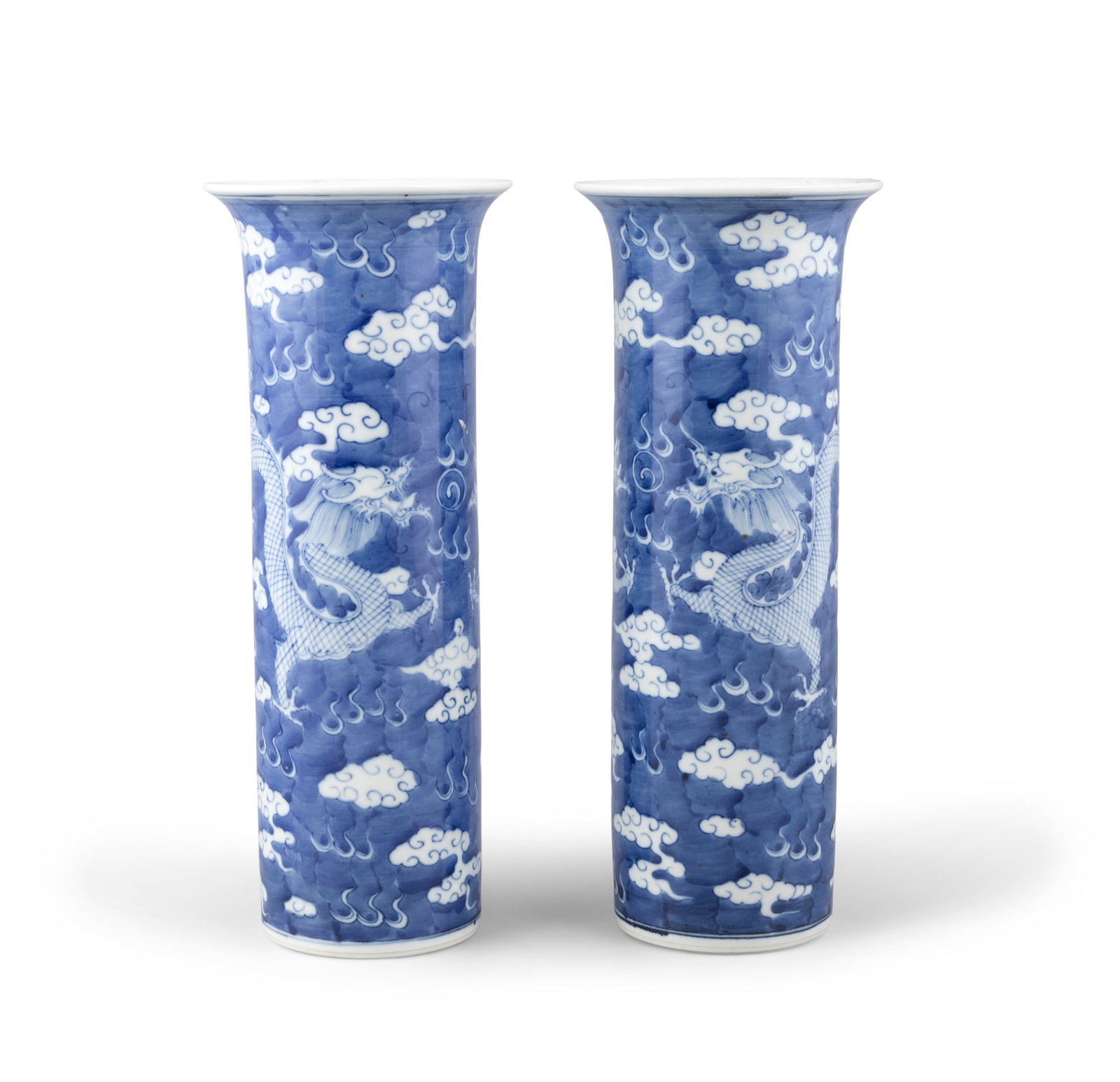 A PAIR OF BLUE AND WHITE ‘DRAGONS IN CLOUDS’ SLEEVE VASES China, 20th century (1 of 3)