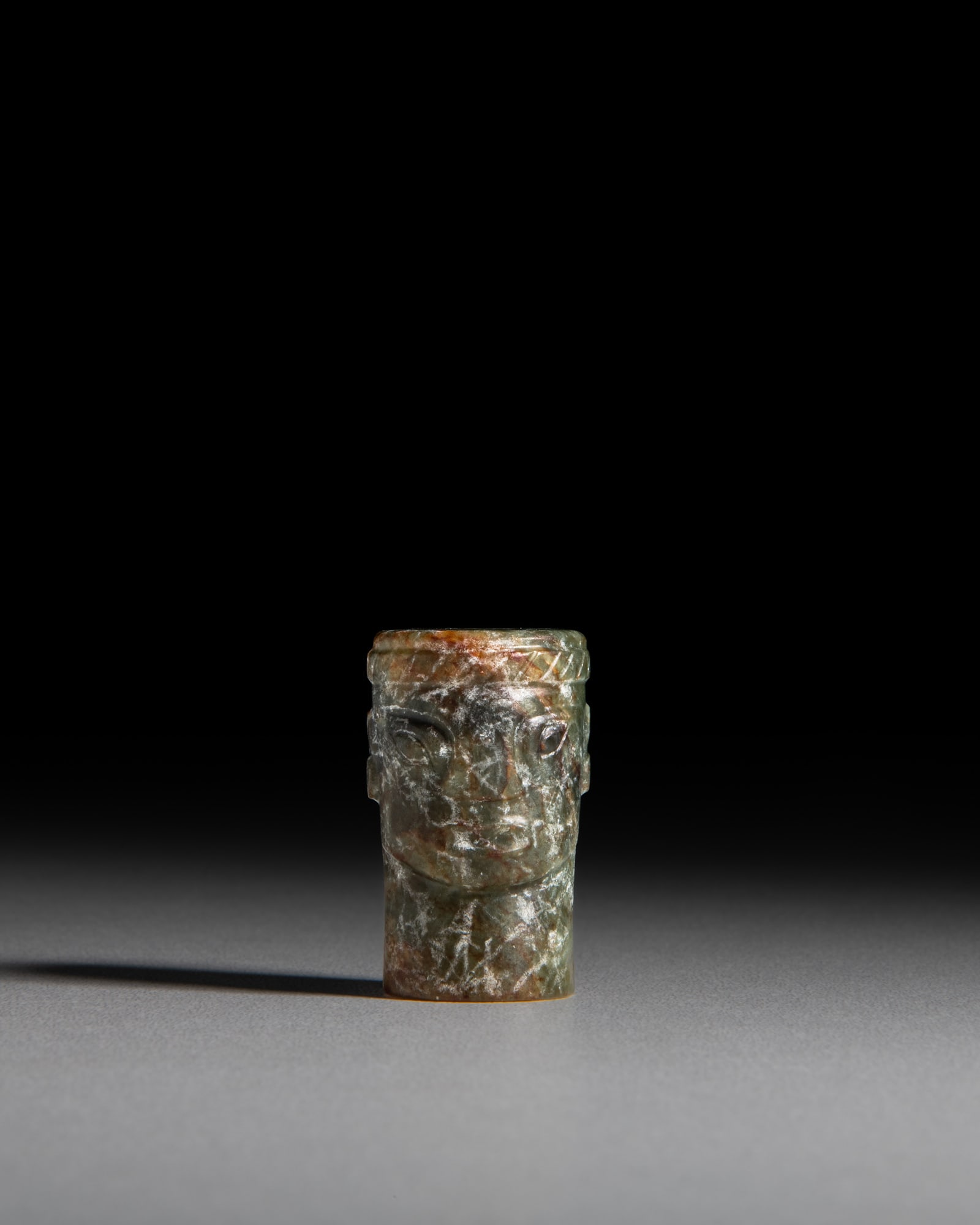 A CELADON JADE MASK-FORM BEAD 石家河文化风格 青 (1 of 4)