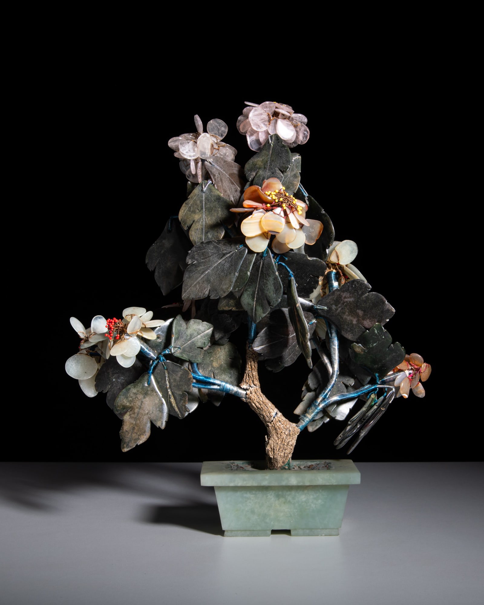 A HARDSTONE-CARVED FLOWER BONSAI PLANTER AND A CARVED MALACHITE FIGURE China, mid 20th century: A HARDSTONE-CARVED FLOWER BONSAI PLANTER AND A CARVED MALACHITE FIGURE China, mid 20th century H.33 and 12cm