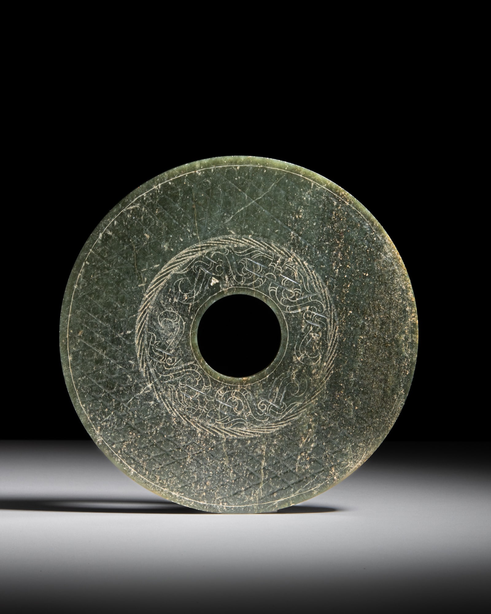 A LARGE WESTERN HAN–STYLE INCISED 'DRAGON' GREEN JADE BI DISC China, 20th century D.22.9cm (1 of 1)