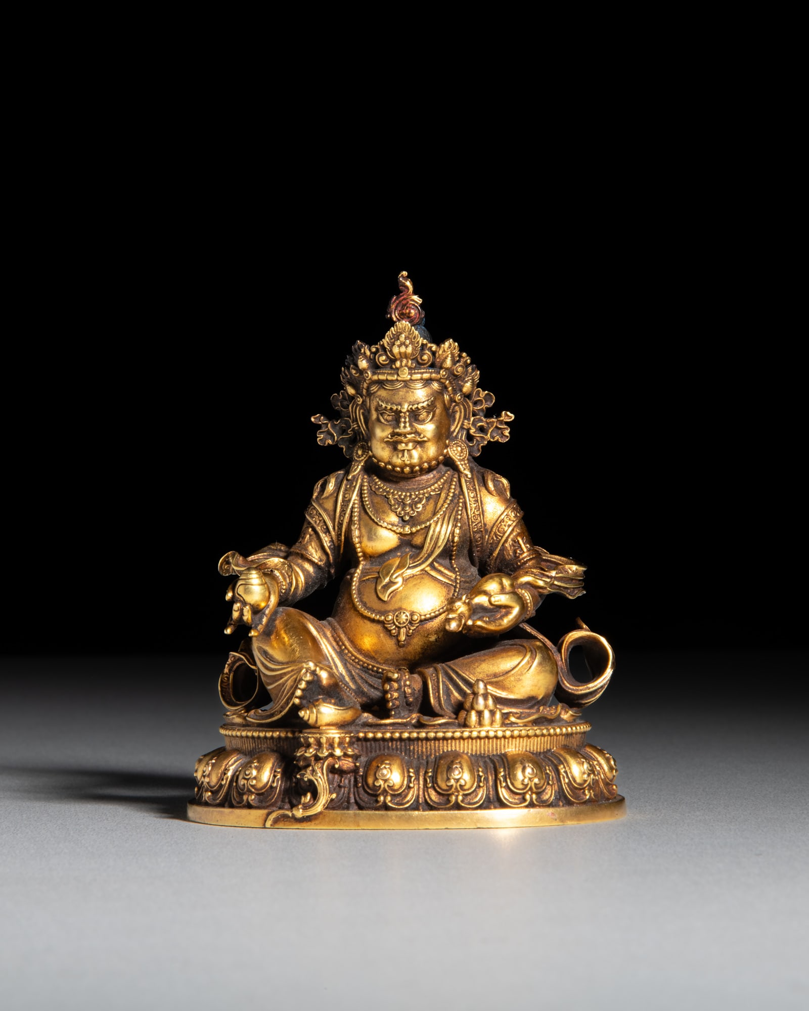A FINE CAST GILT BRONZE FIGURE OF JAMBHALA Tibet, 20th century H.10cm (1 of 4)