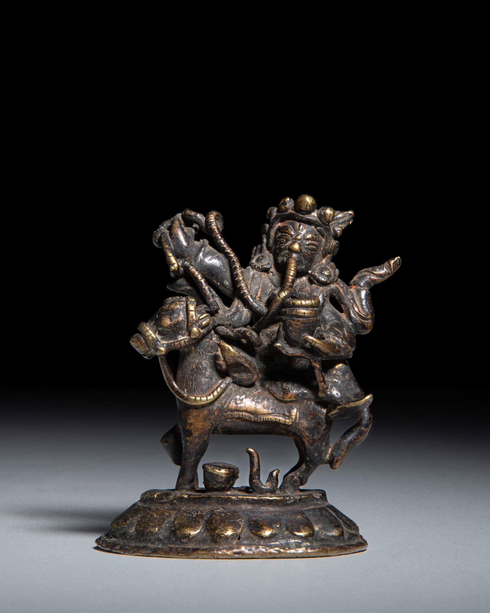 A COPPER ALLOY FIGURE OF A TANTRIC DEITY RIDING A HORSE Tibet-Nepal, early-middle 20th Century (1 of 3)