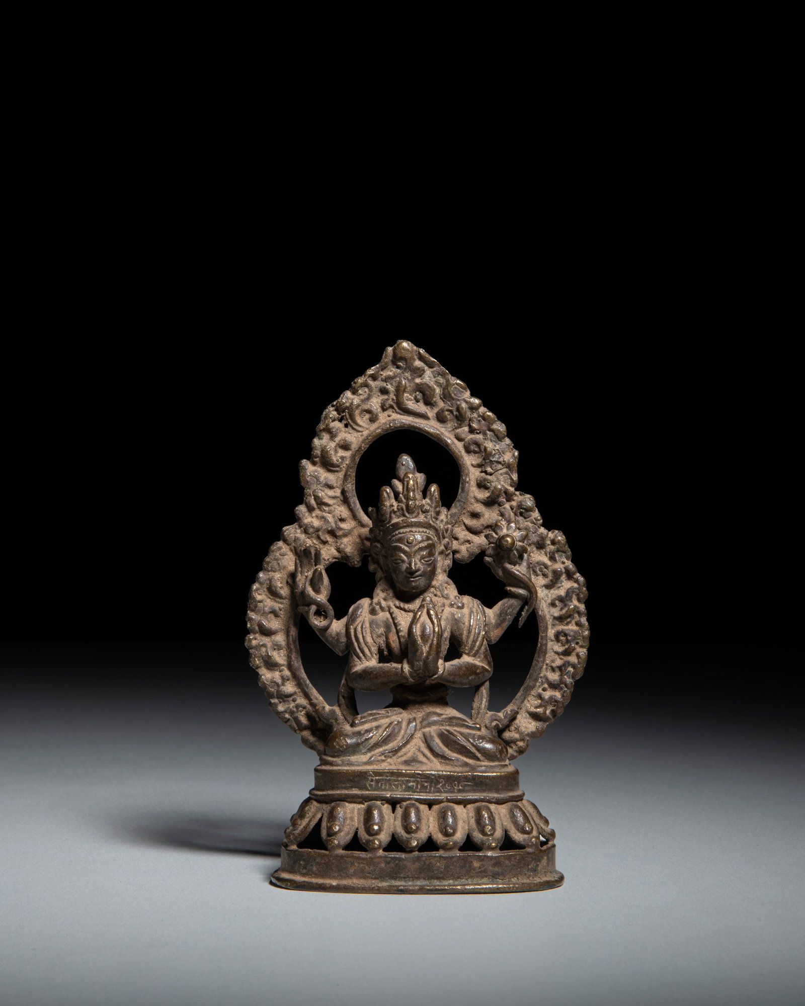 A DARK BRONZE FOUR-ARMED SADAKSARI-AVALOKITESHVARA Nepal, circa 1958 depicts: A DARK BRONZE FOUR-ARMED SADAKSARI-AVALOKITESHVARA Nepal, circa 1958 depicts Sadaksari-Avalokiteshvara, the four-armed personification of the sacred six-syllable mantra Om Mani Padme Hum. The deity is