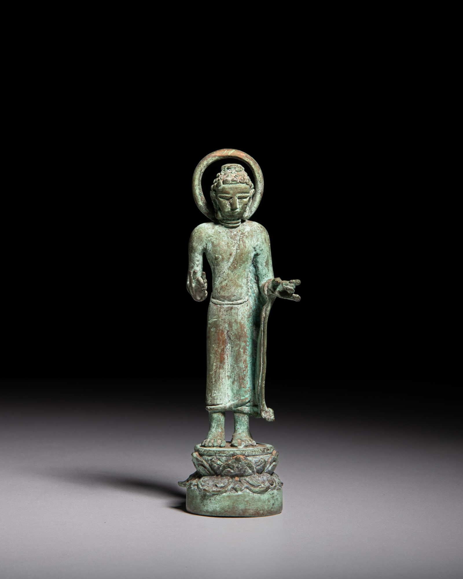 A GREEN PATINATED BRONZE FIGURE OF A STANDING BUDDHA Thailand, Dvaravati style, 20th Century (1 of 3)