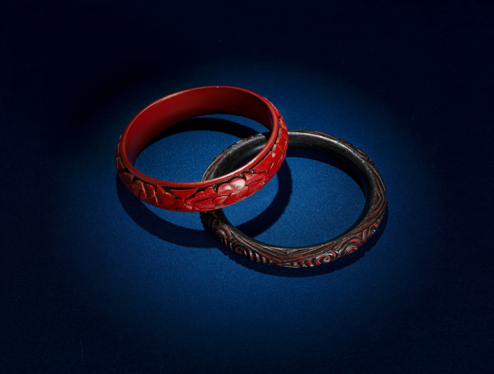TWO CINNABAR CARVED BANGLE BRACELETS China, 20th century. D.(outside)8.1-7.6cm - (inside)6.2-6.4cm (1 of 1)