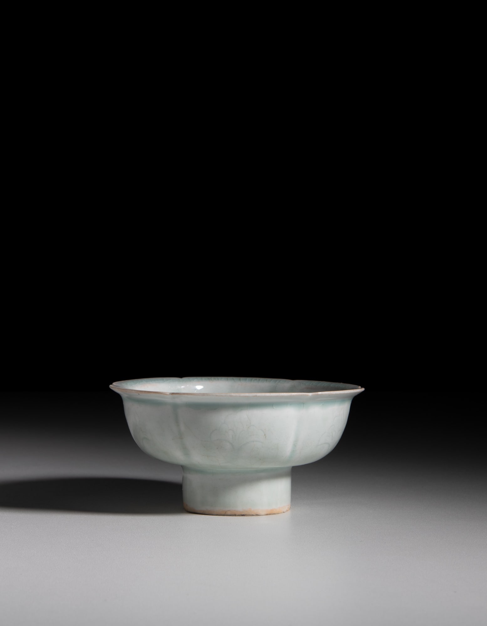 A LOBED QINGBAI GLAZED 'FLOWER' STEM CUP 宋代风格 青白刻: A LOBED QINGBAI GLAZED 'FLOWER' STEM CUP 宋代风格 青白刻花高足花口盌 China, Song style D.12.4cm with a wooden box