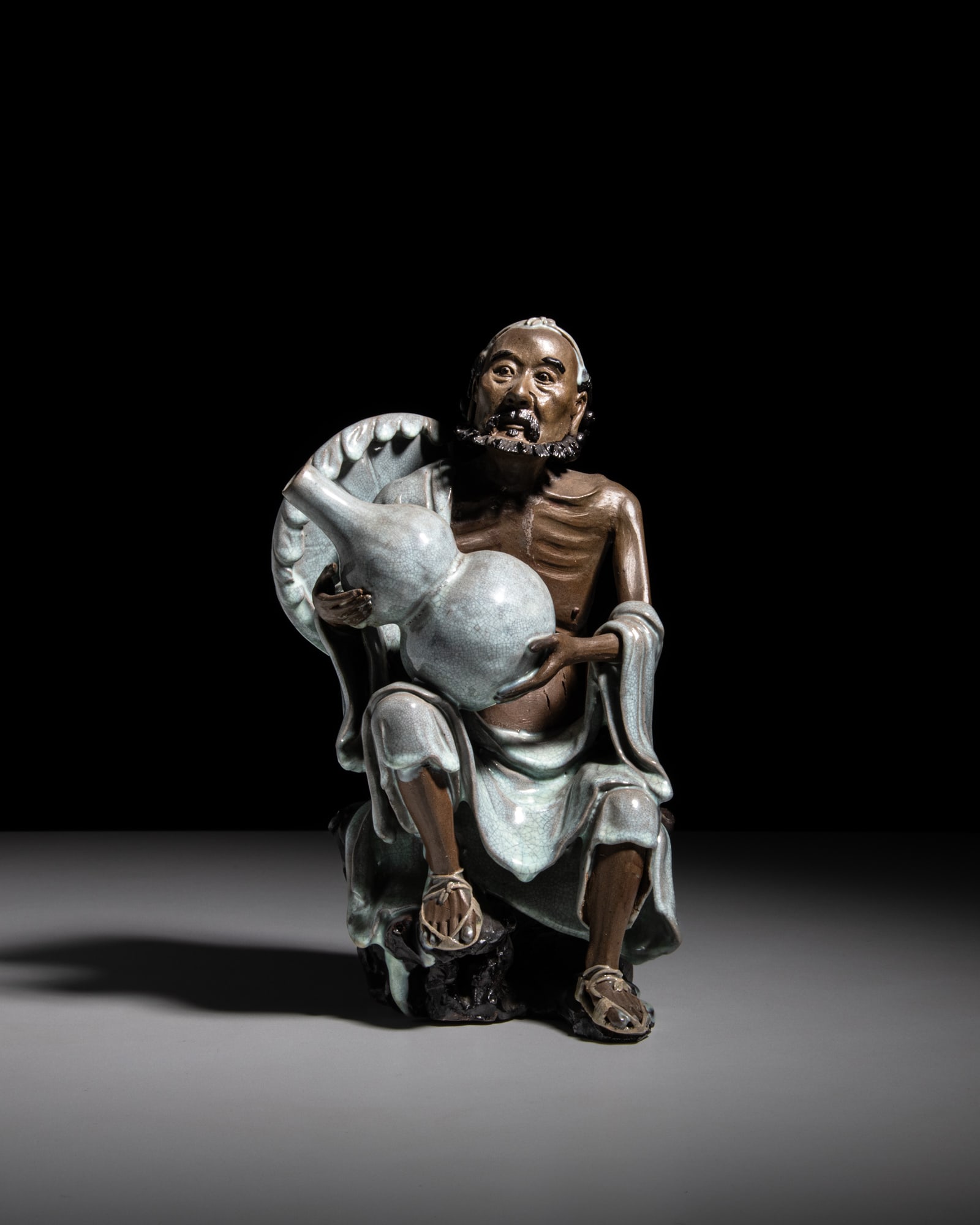 A SHIWAN POTTERY FIGURE OF LUOHAN WITH A GOURD 20世纪 石湾雕瓷 (1 of 2)