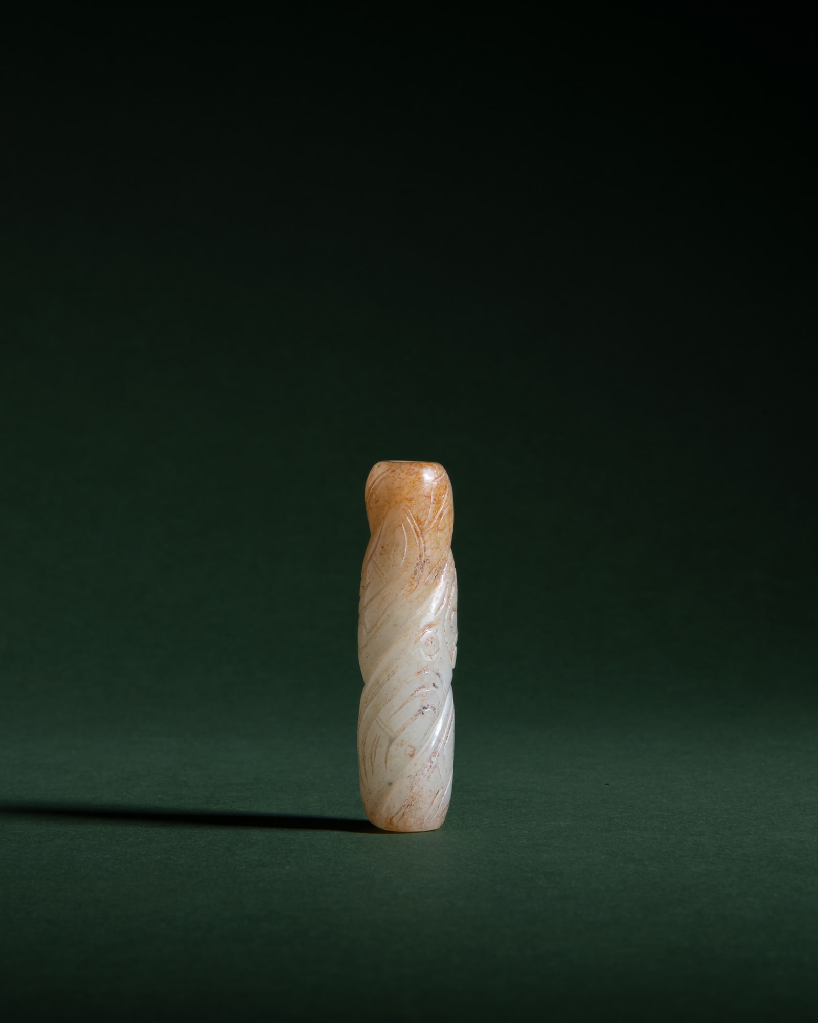 A SHANG STYLE CELADON JADE 'TIGER' BEAD 仿商 青玉带沁色&#: A SHANG STYLE CELADON JADE 'TIGER' BEAD 仿商 青玉带沁色虎纹珠 China, 20th century H.6cm ***PLEASE NOTE: THIS LOT IS NOT ON VIEW IN IRELAND. 