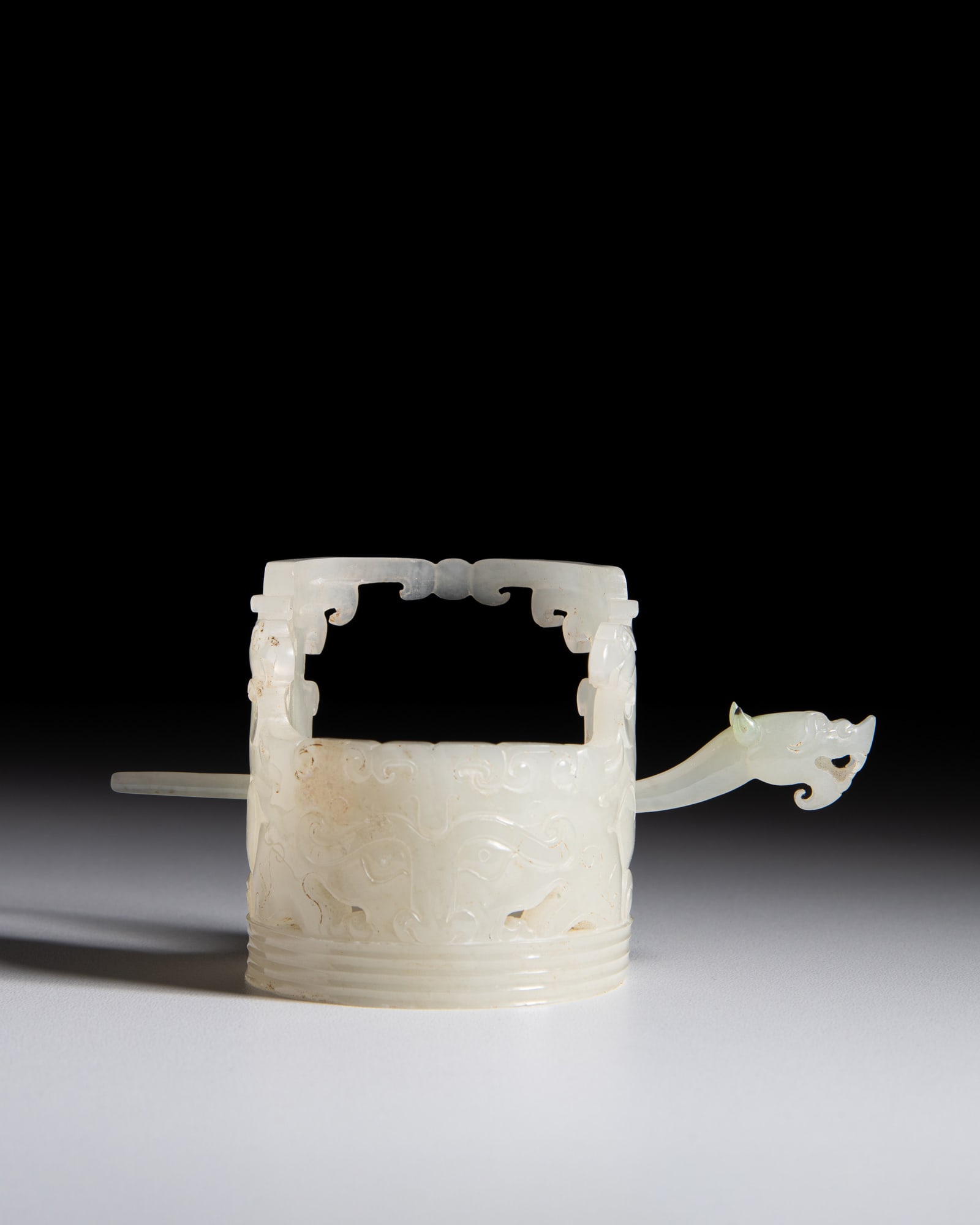 A RETICULATED PALE JADE ARCHAICAL PHOENIX AND TAOTIE HAIR ORNAMENT AND DRAGON HEAD HAIRPIN (1 of 3)