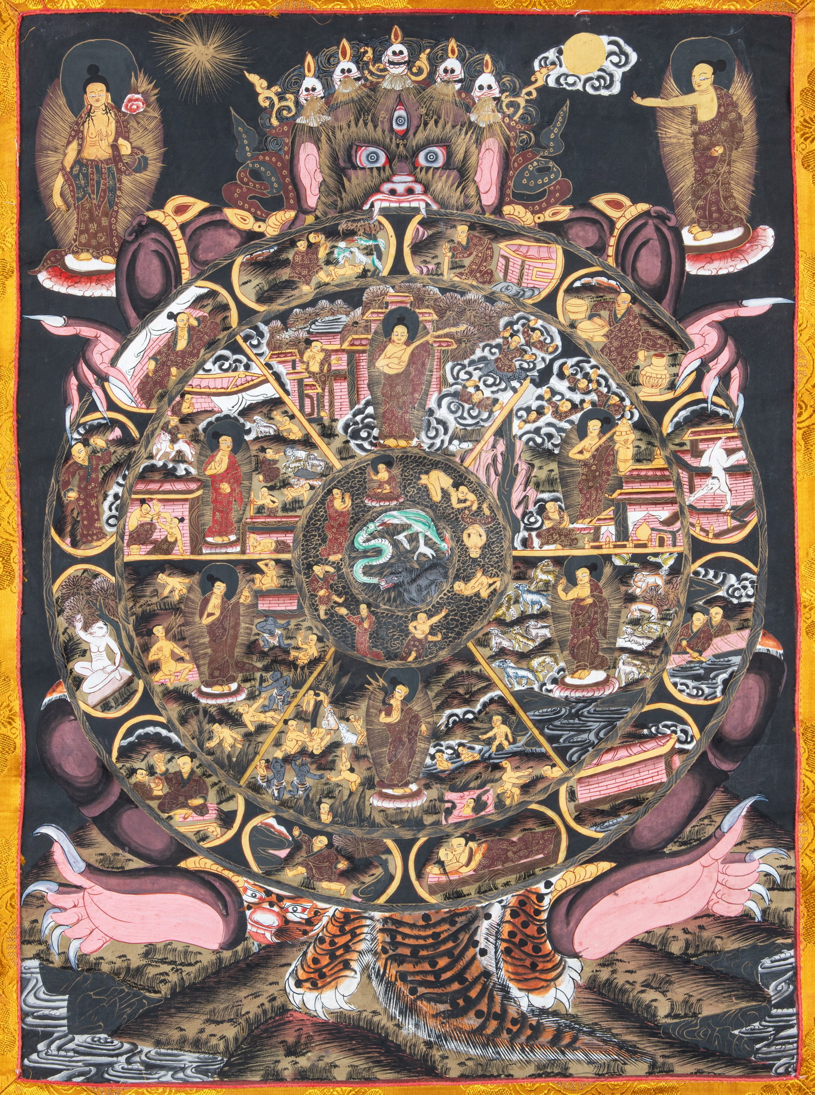 A POLYCHROME AND GILT THANGKA ON CLOTH DEPICTING WHEEL OF LIFE (BHAVACHAKRA) Nepal, 20th Century. (1 of 2)