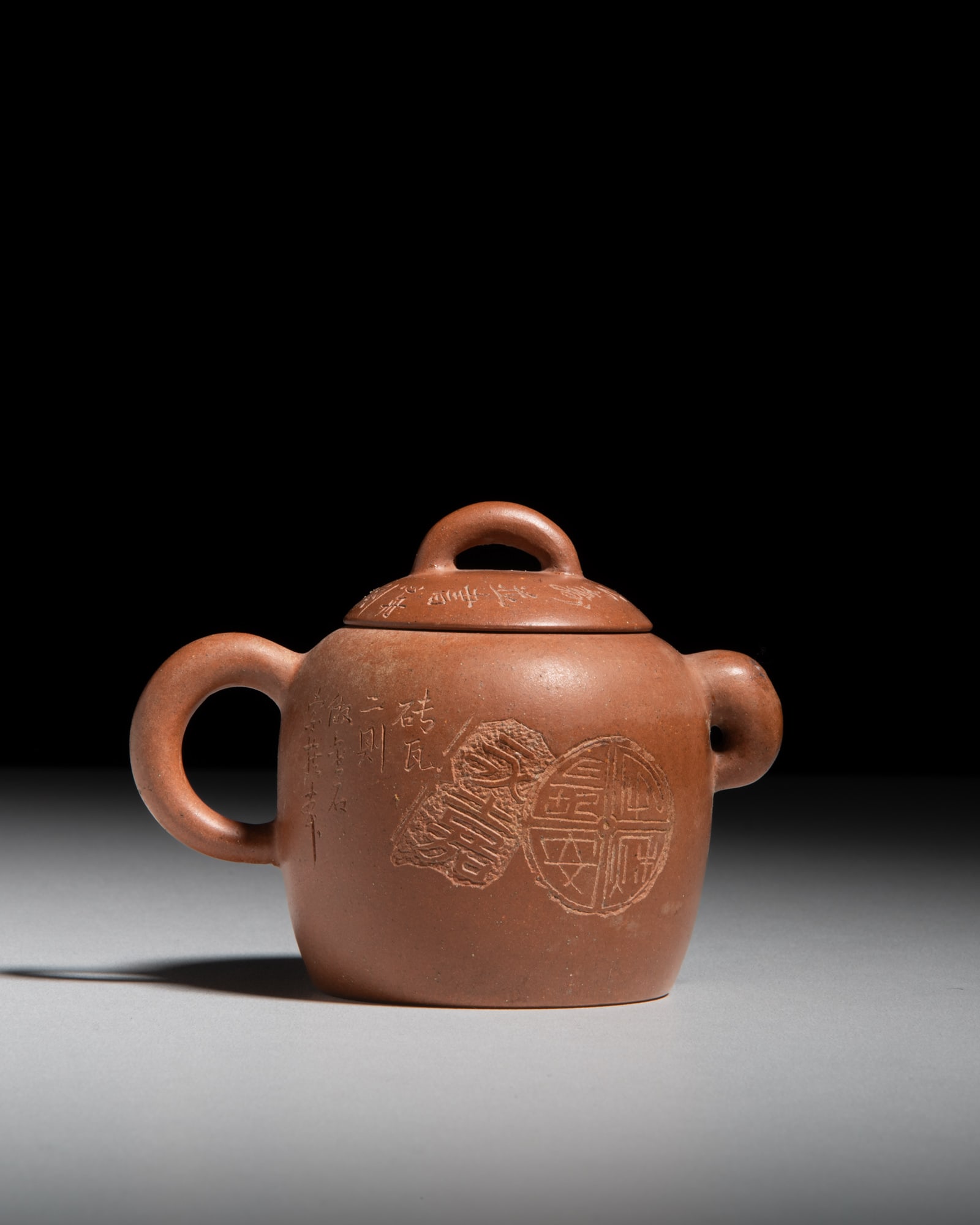 AFTER HE XIN ZHOU (1829-1897) A carved 'Tiles and Epigraphic Treasures' zisha teapot 何 (1 of 5)