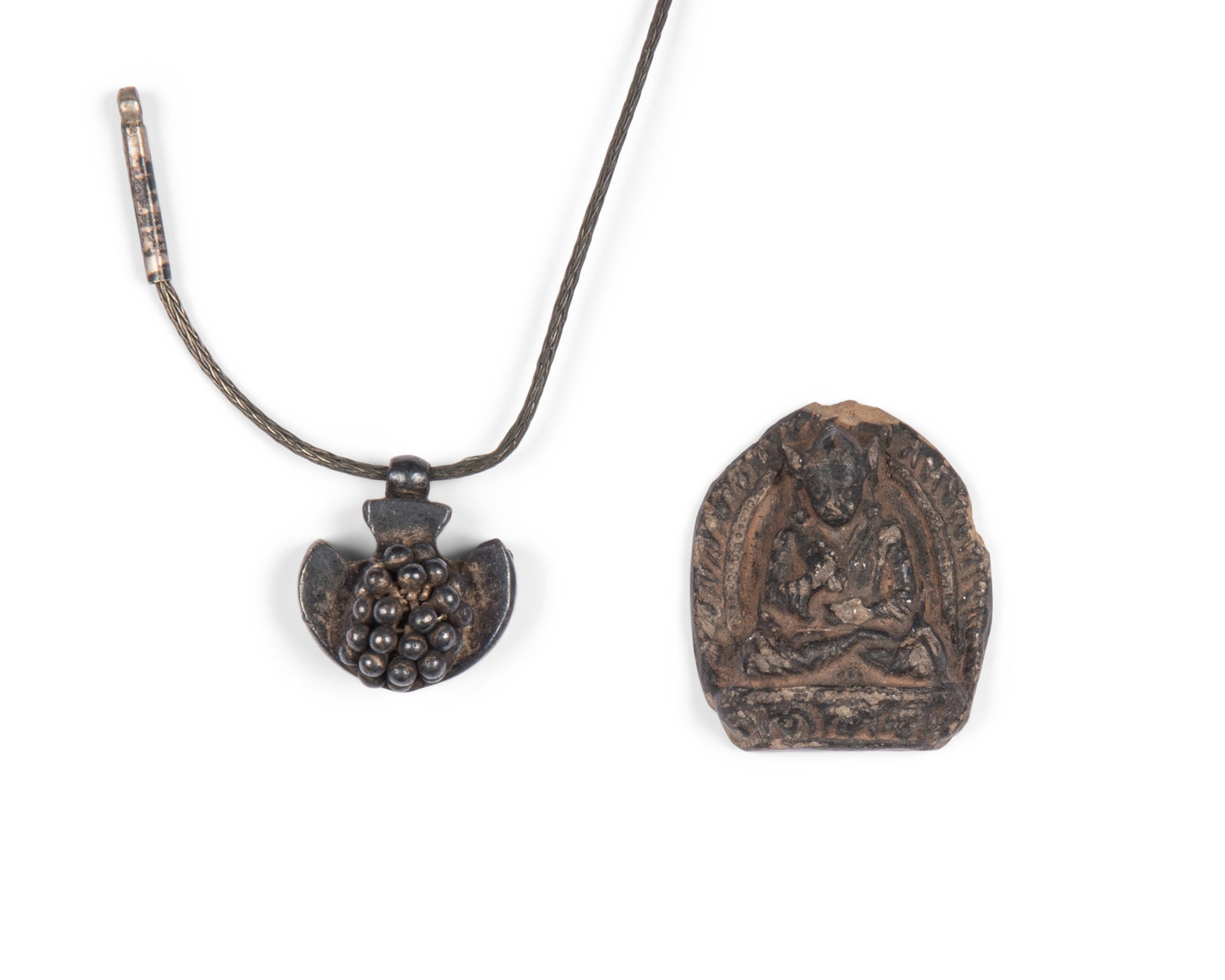 A SMALL CERAMIC TSA-TSA FEATURING PADMASAMBHAVA, Tibet/Nepal, late 19th or 20th century H: 3.2cm; (1 of 1)