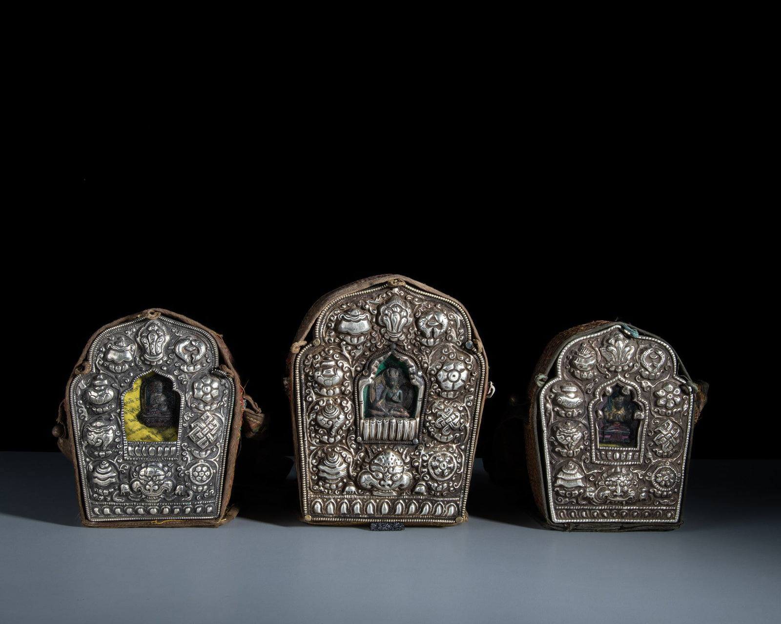 A SET OF THREE SHRINE-SHAPED MIXED-METAL GAU BOXES WITH THEIR CONTENTS AND CLOTH COVERS Tibet or (1 of 1)