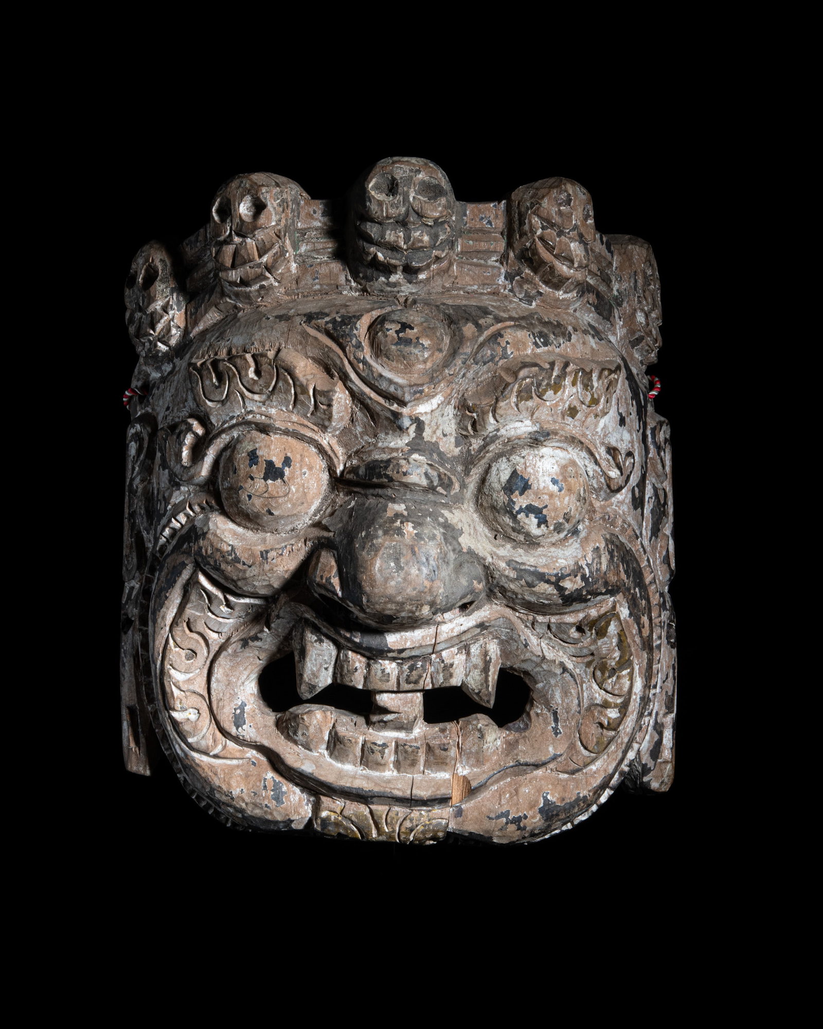 A CARVED WOOD RITUAL MASK OF A BLACK MAHAKALA WITH CITIPATTI CROWN Tibet-Nepal, 20th Century. With: A CARVED WOOD RITUAL MASK OF A BLACK MAHAKALA WITH CITIPATTI CROWN Tibet-Nepal, 20th Century. With some traces of polychrome pigments H: 25.5 cm W: 23 cm Provenance: from the collection of a prominent
