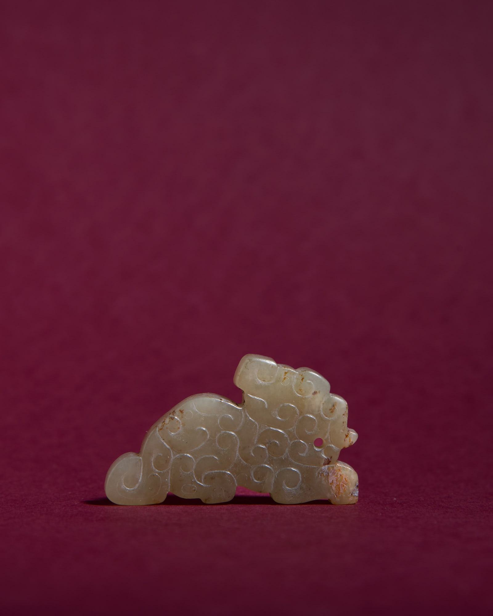 A CELADON JADE SPRING AND AUTUMN STYLE 'LION' PENDANT 民国仿春秋 (1 of 2)